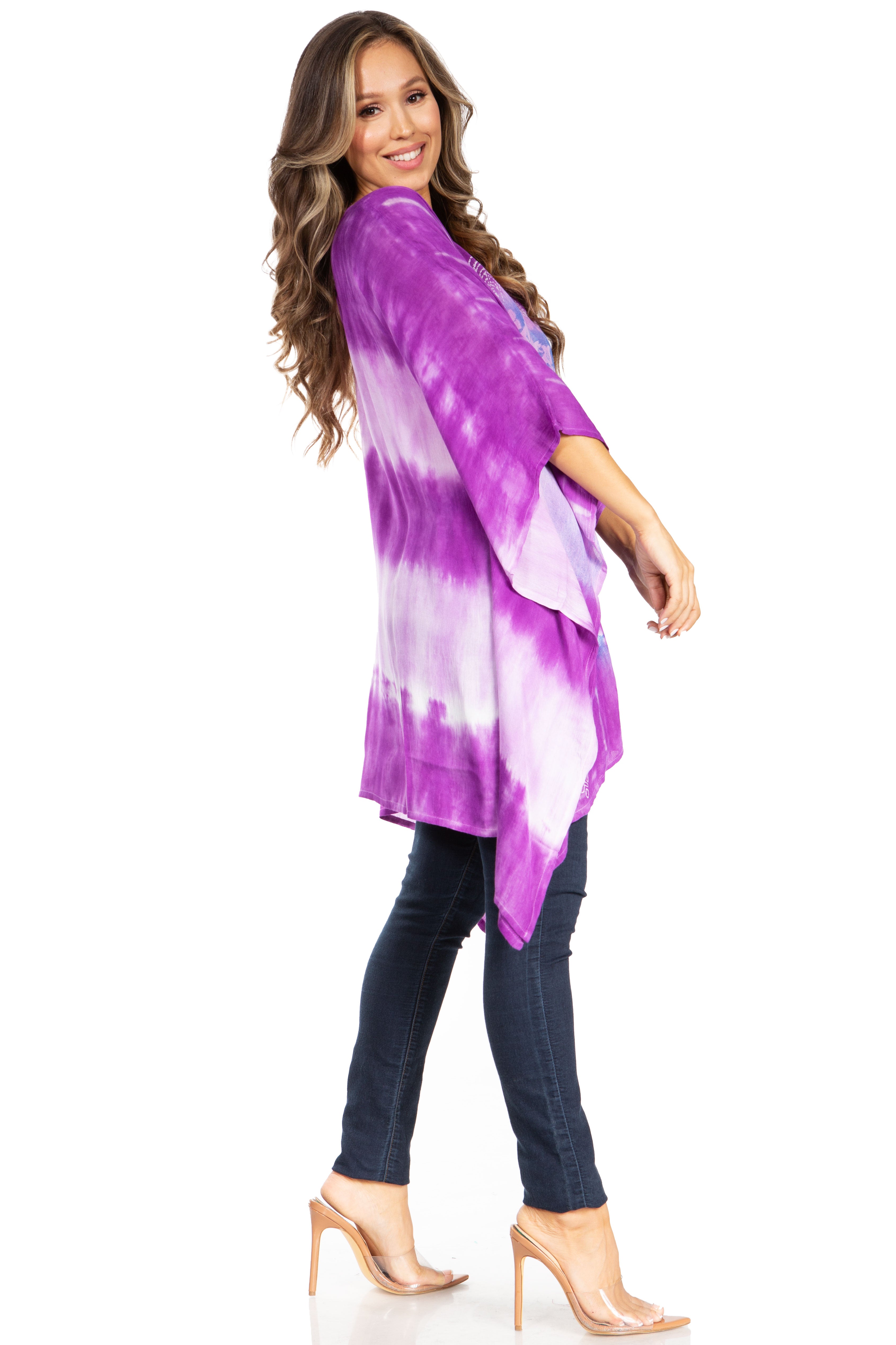 Woman wearing a purple and white tie-dye kimono over a black outfit on a white background