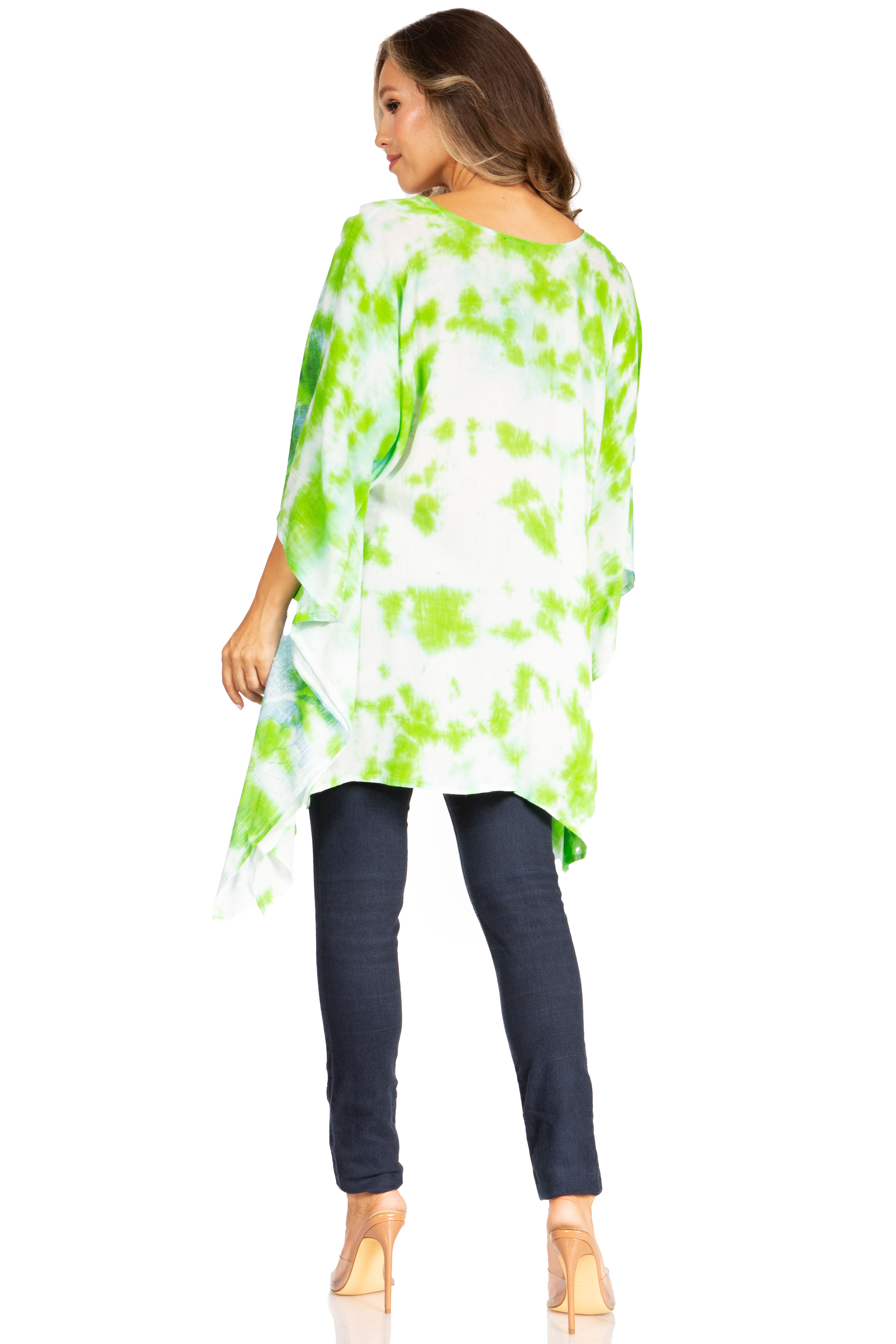 Woman wearing a green and white tie-dye shirt with dark jeans on a white background