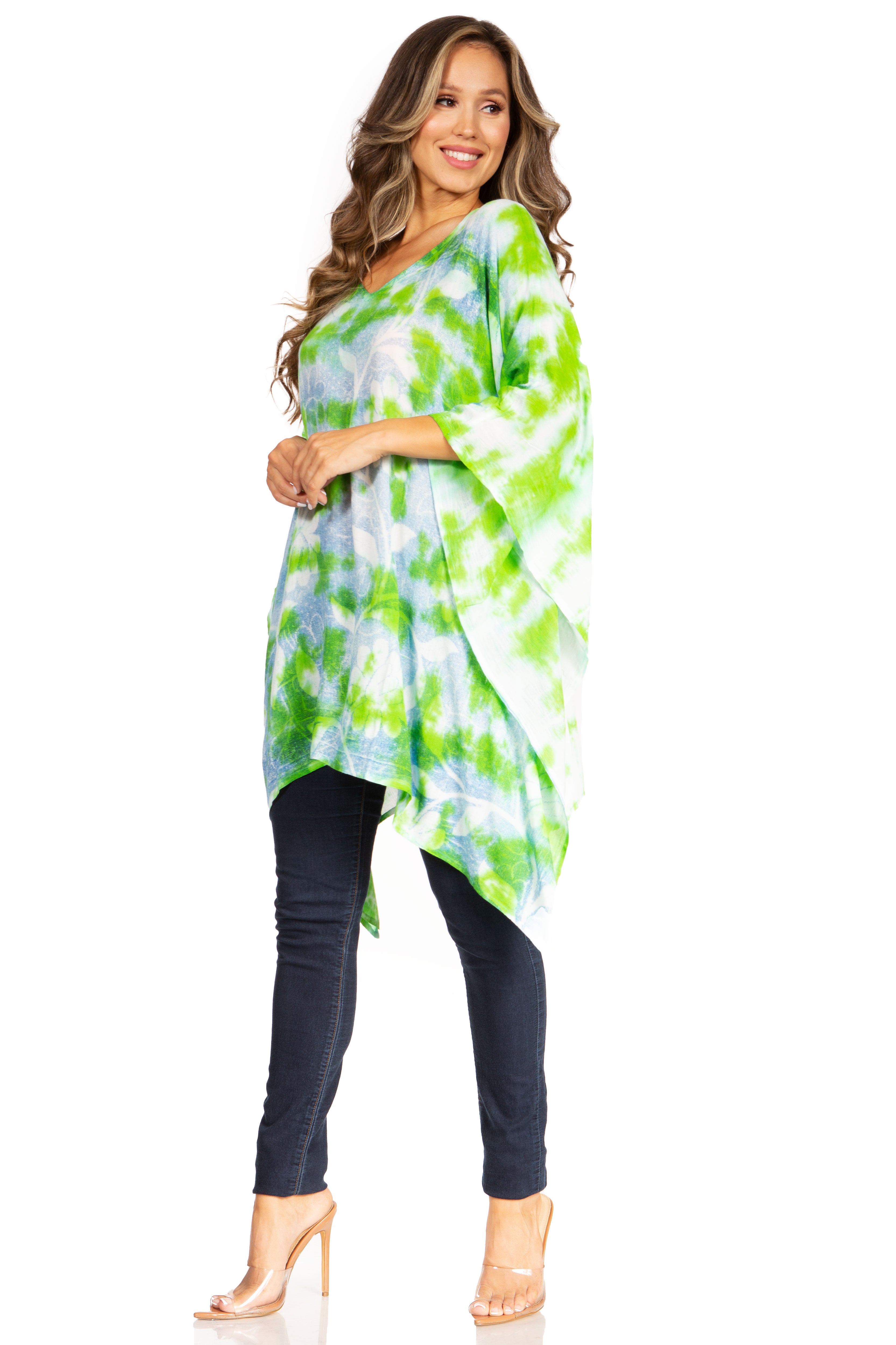 Woman wearing a green and white tie-dye top with dark pants on a white background
