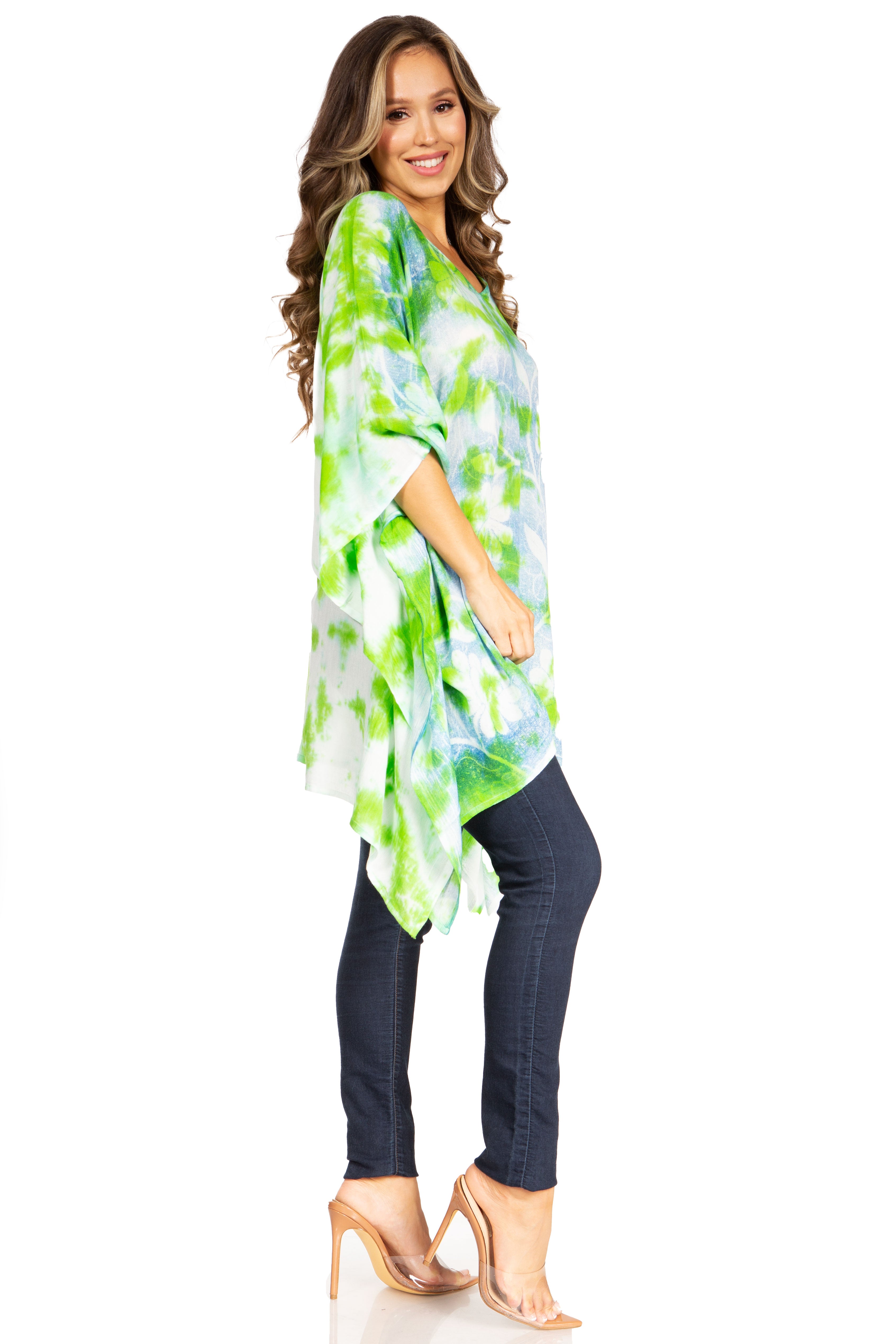 Woman wearing a green and white patterned poncho on a white background