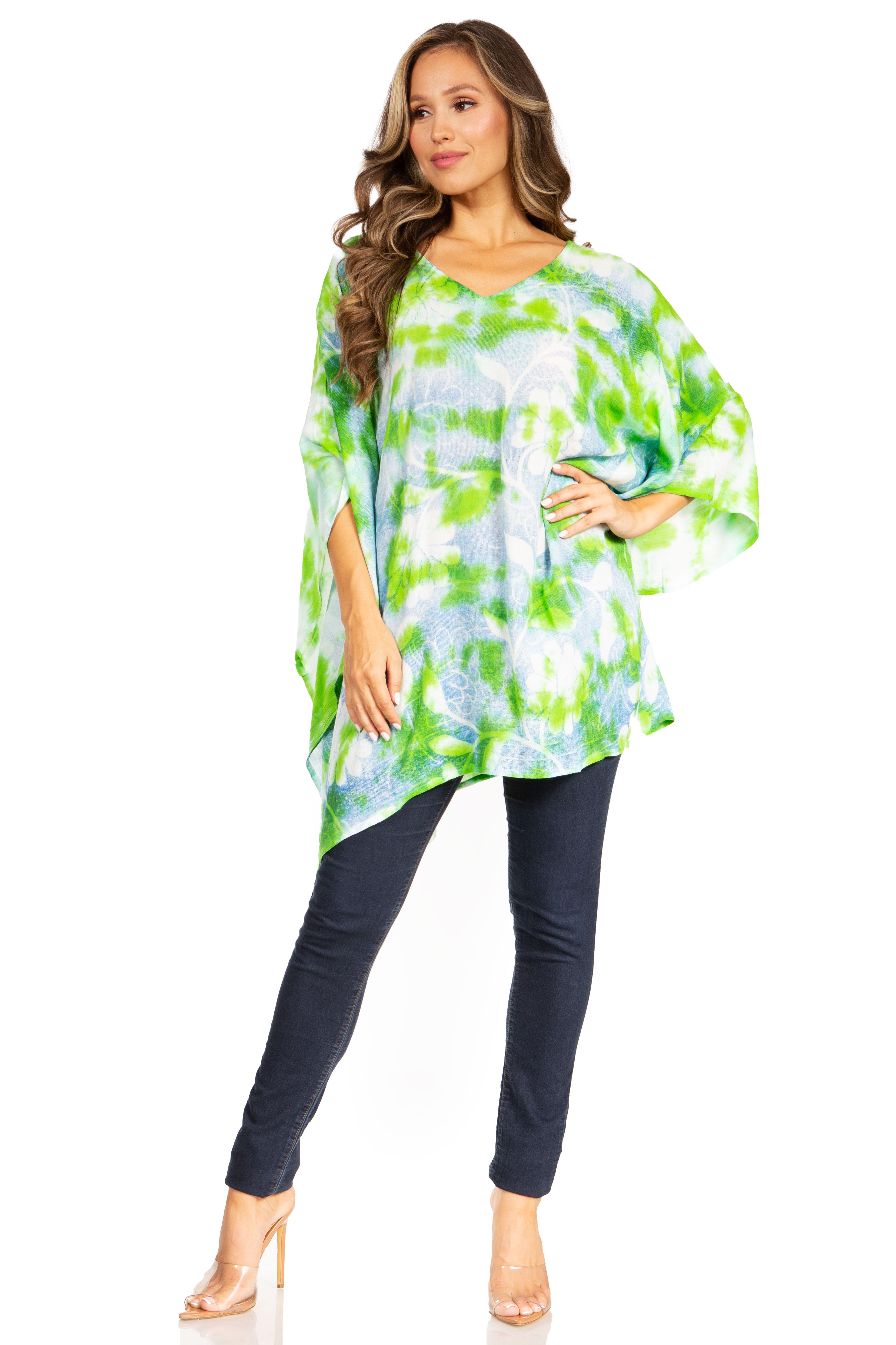 Woman wearing a colorful tie-dye top and dark pants on a white background