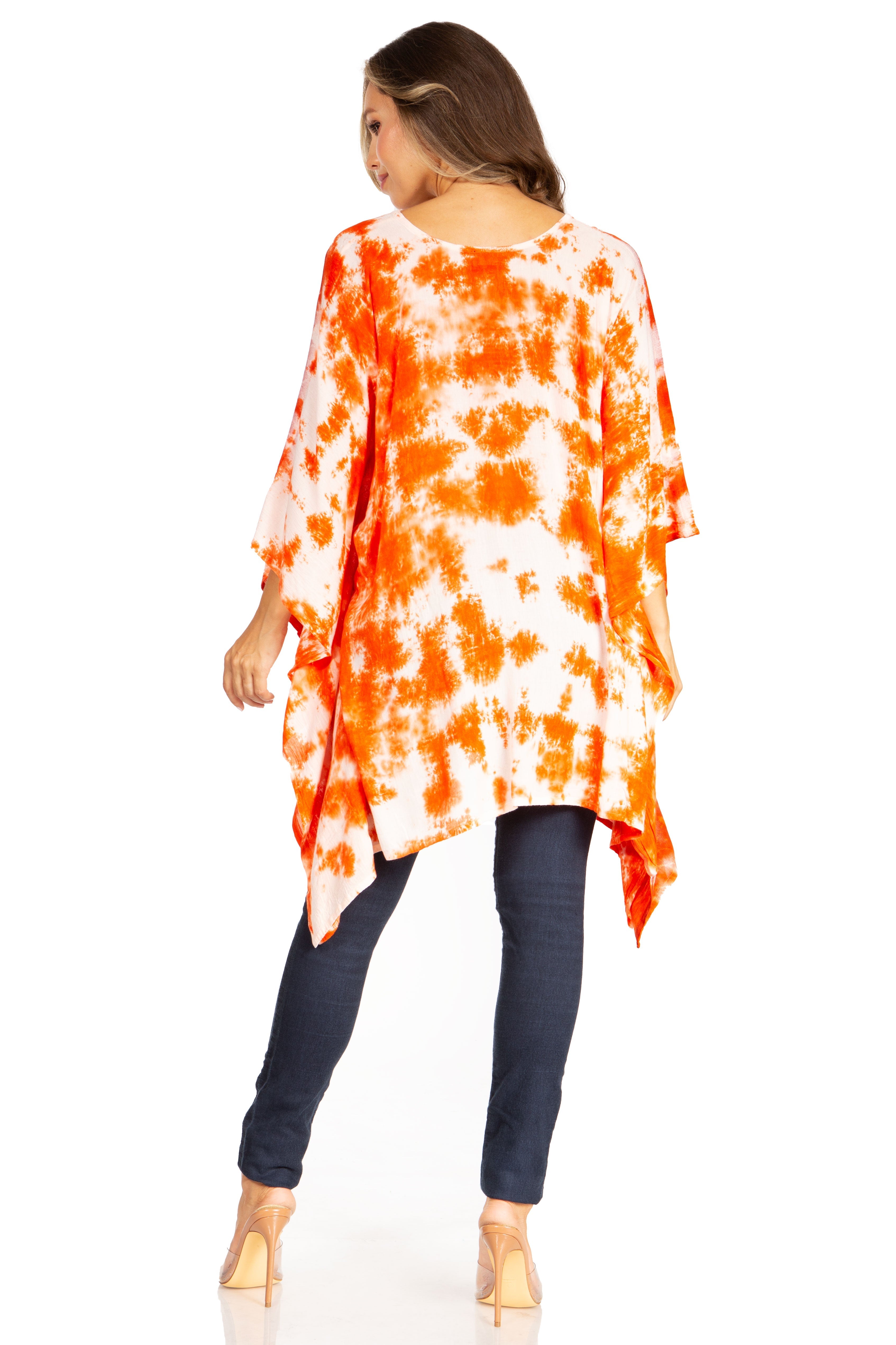 Woman wearing an orange and white tie-dye shirt with navy pants on a white background