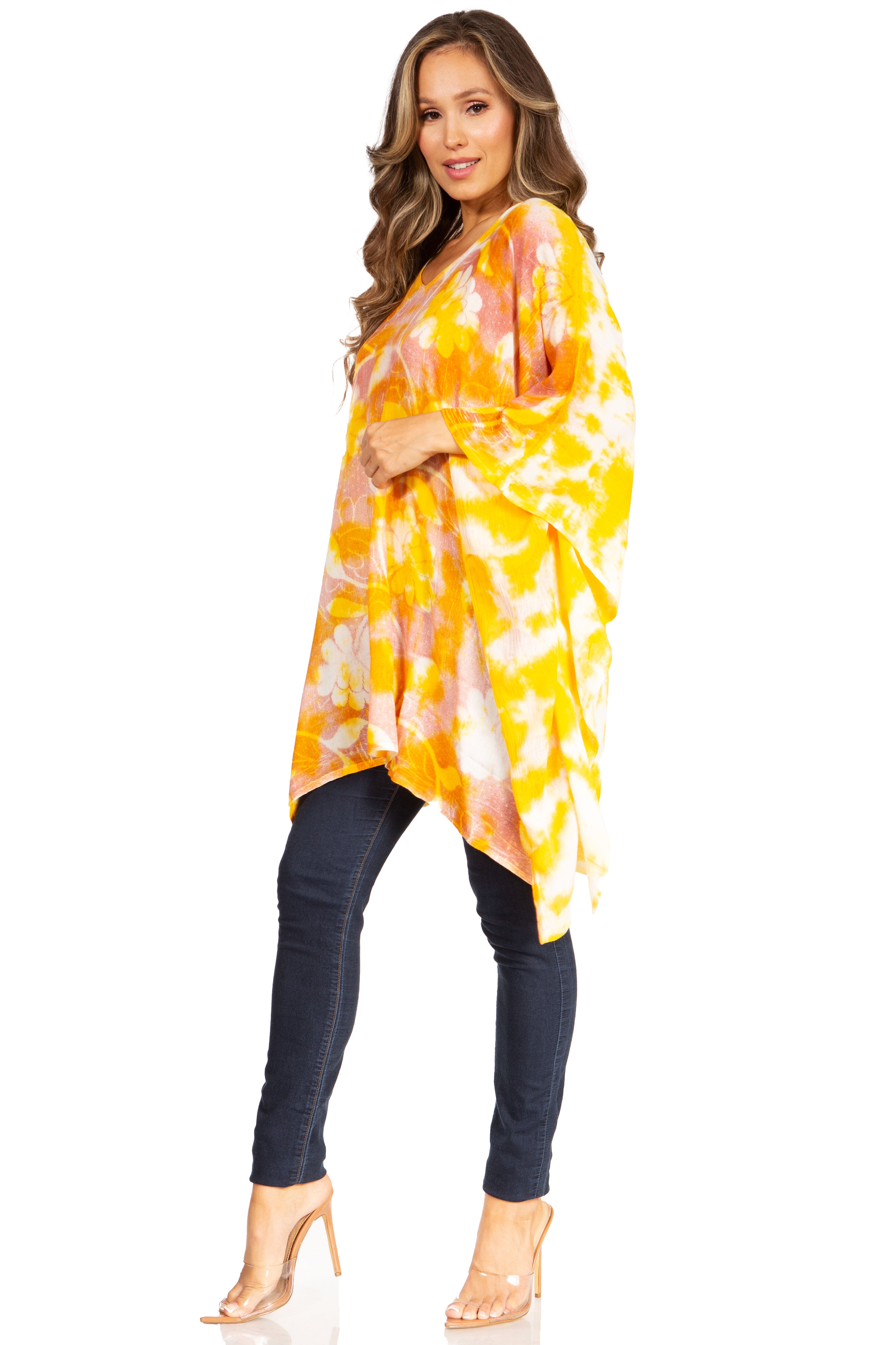 Woman wearing a yellow and orange tie-dye kimono over a black outfit on a white background