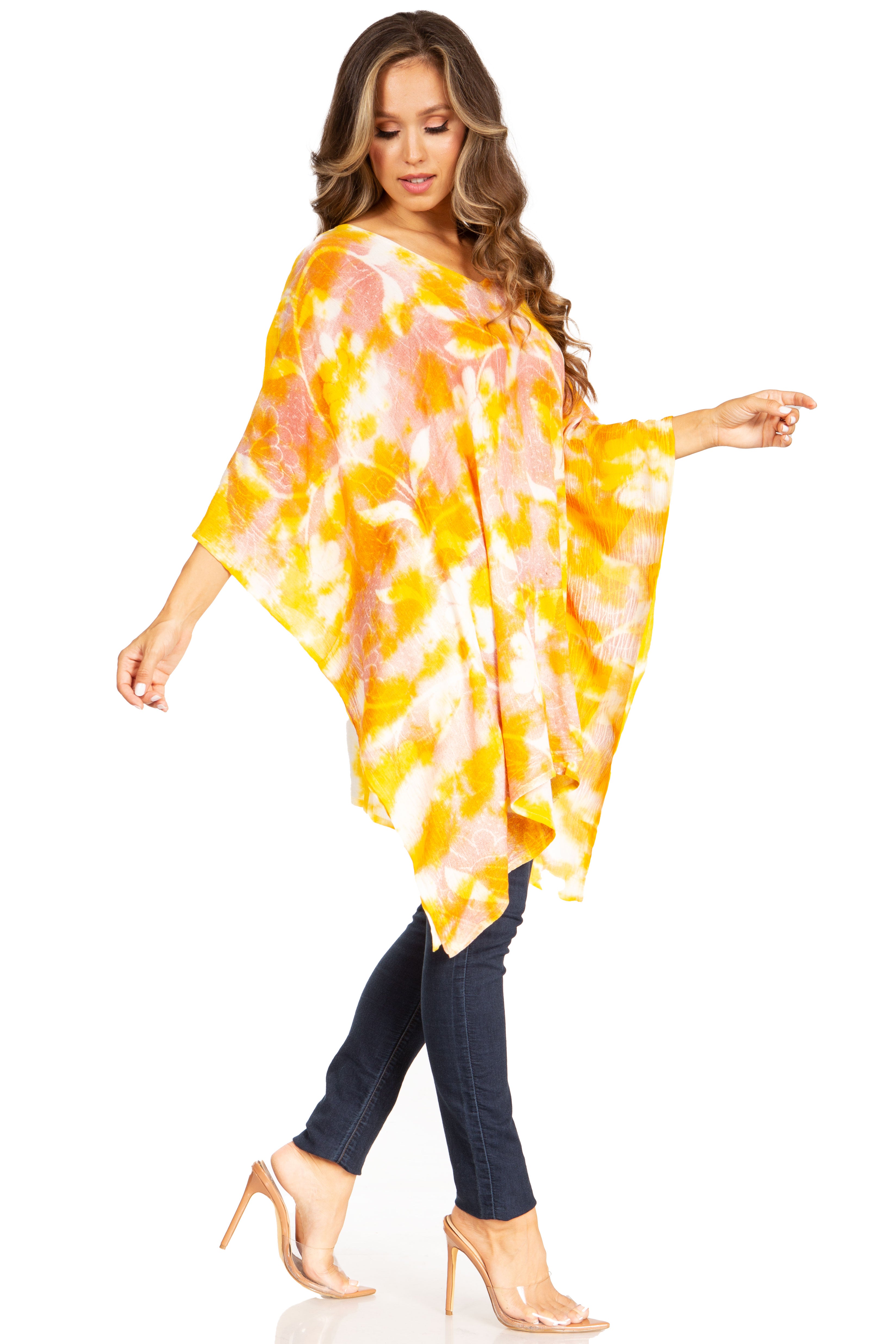 Woman wearing a colorful tie-dye poncho on a white background