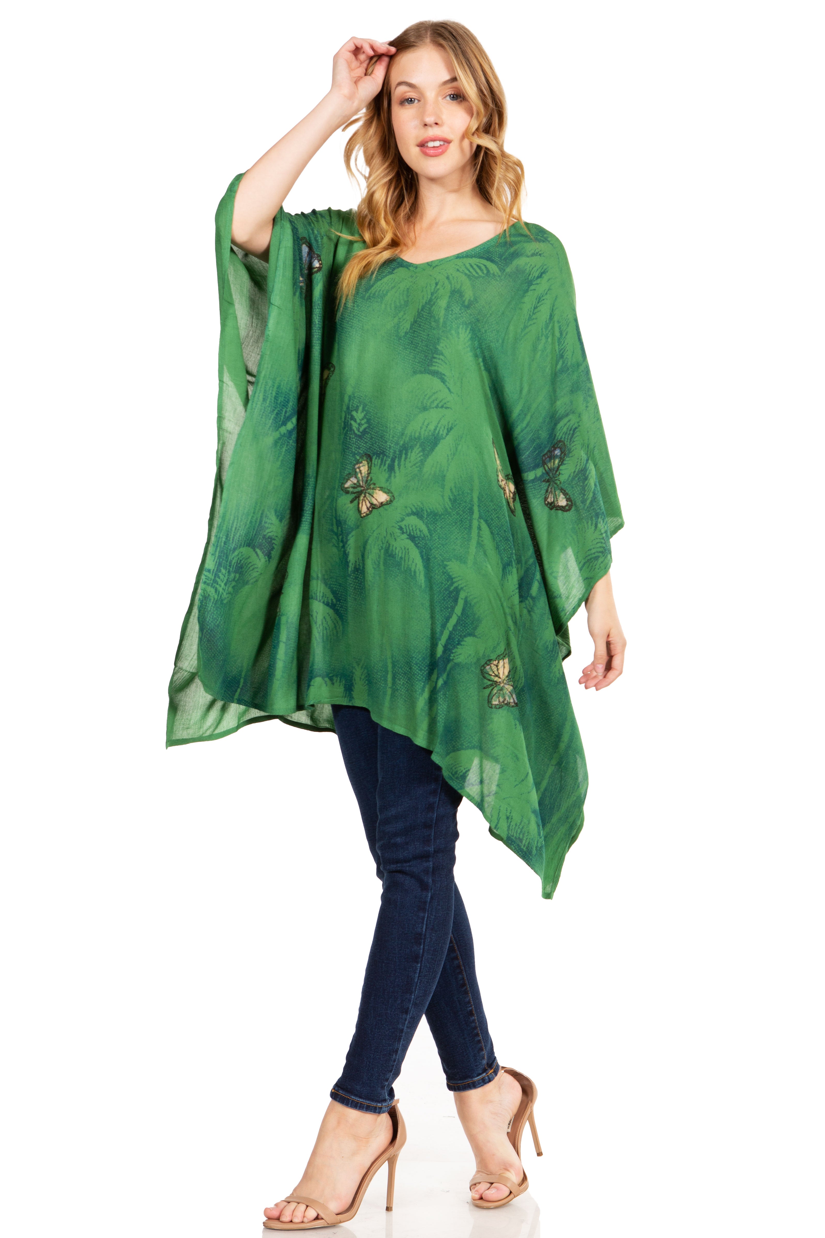 Woman wearing a green leaf-patterned poncho on a white background