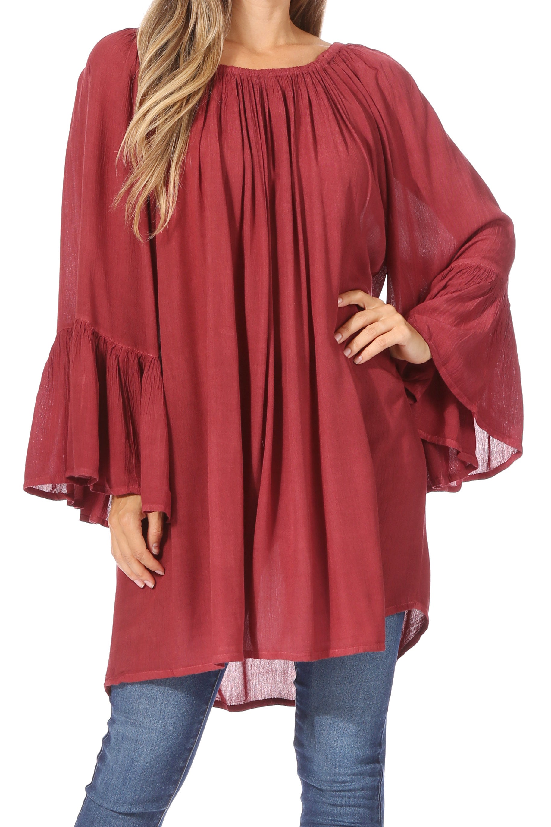 Red blouse with bell sleeves worn by a person on a white background
