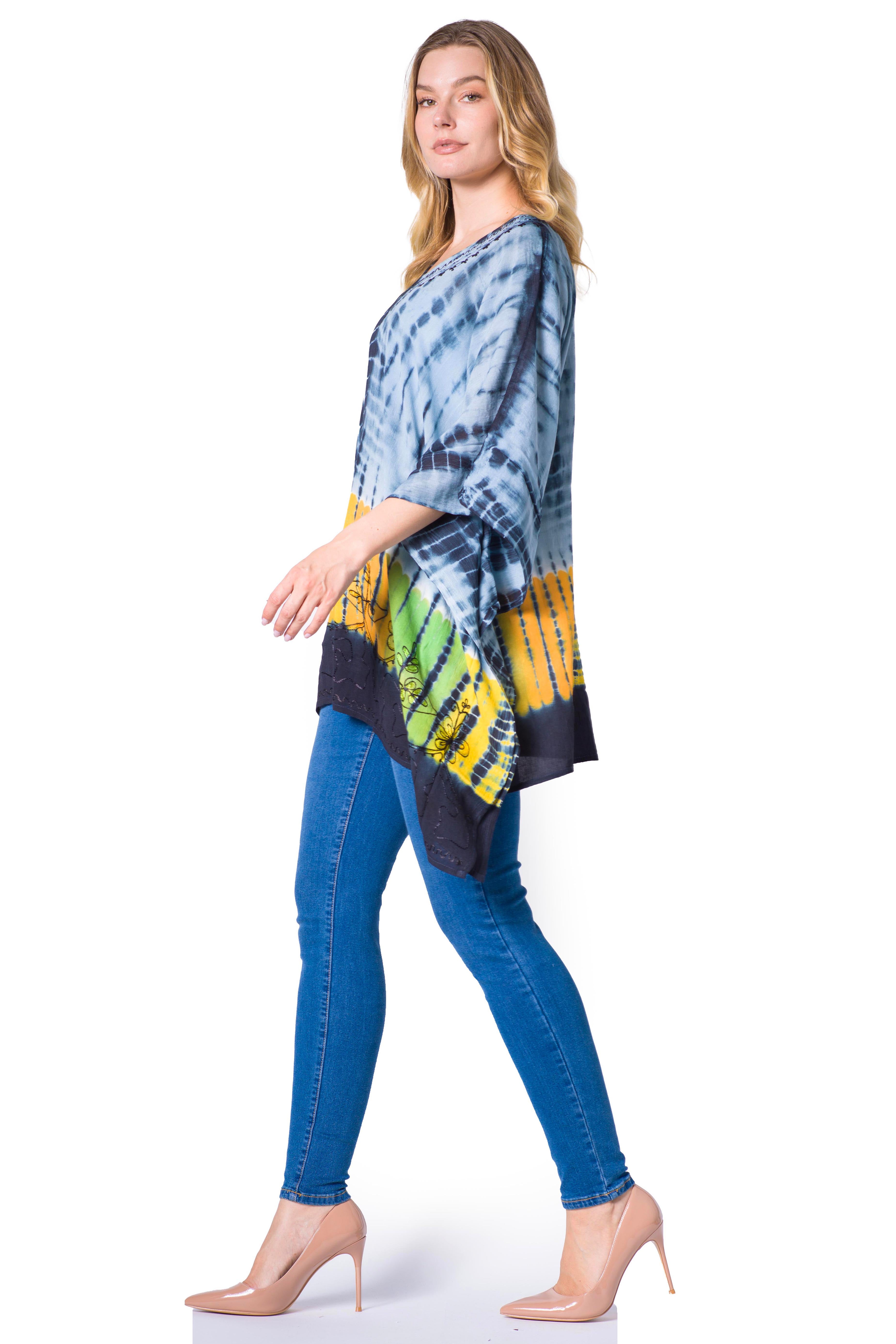 Woman wearing a tie-dye top and blue jeans on a white background