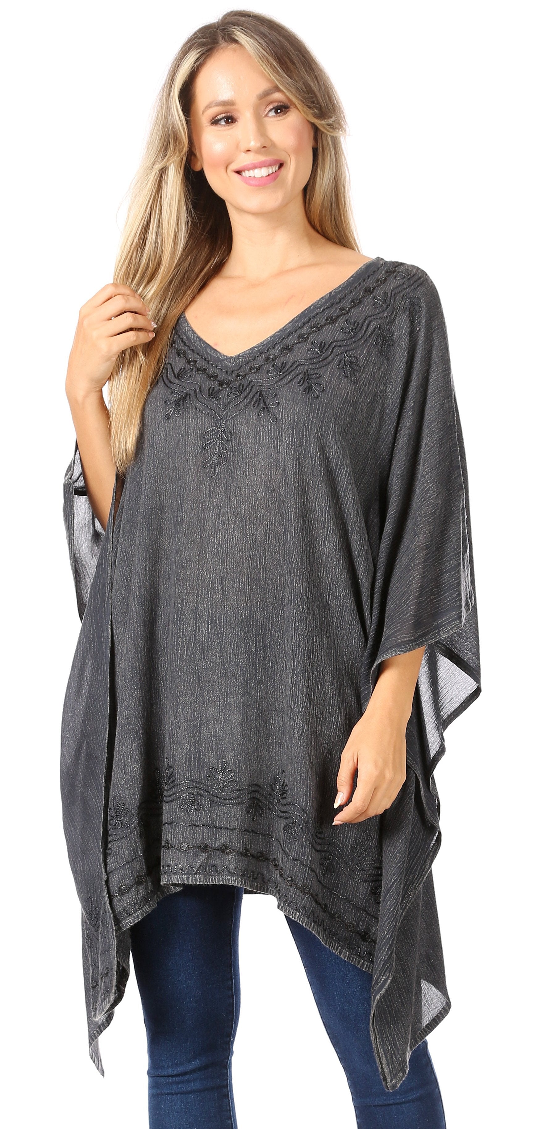 Woman wearing a gray poncho with lace details on a white background