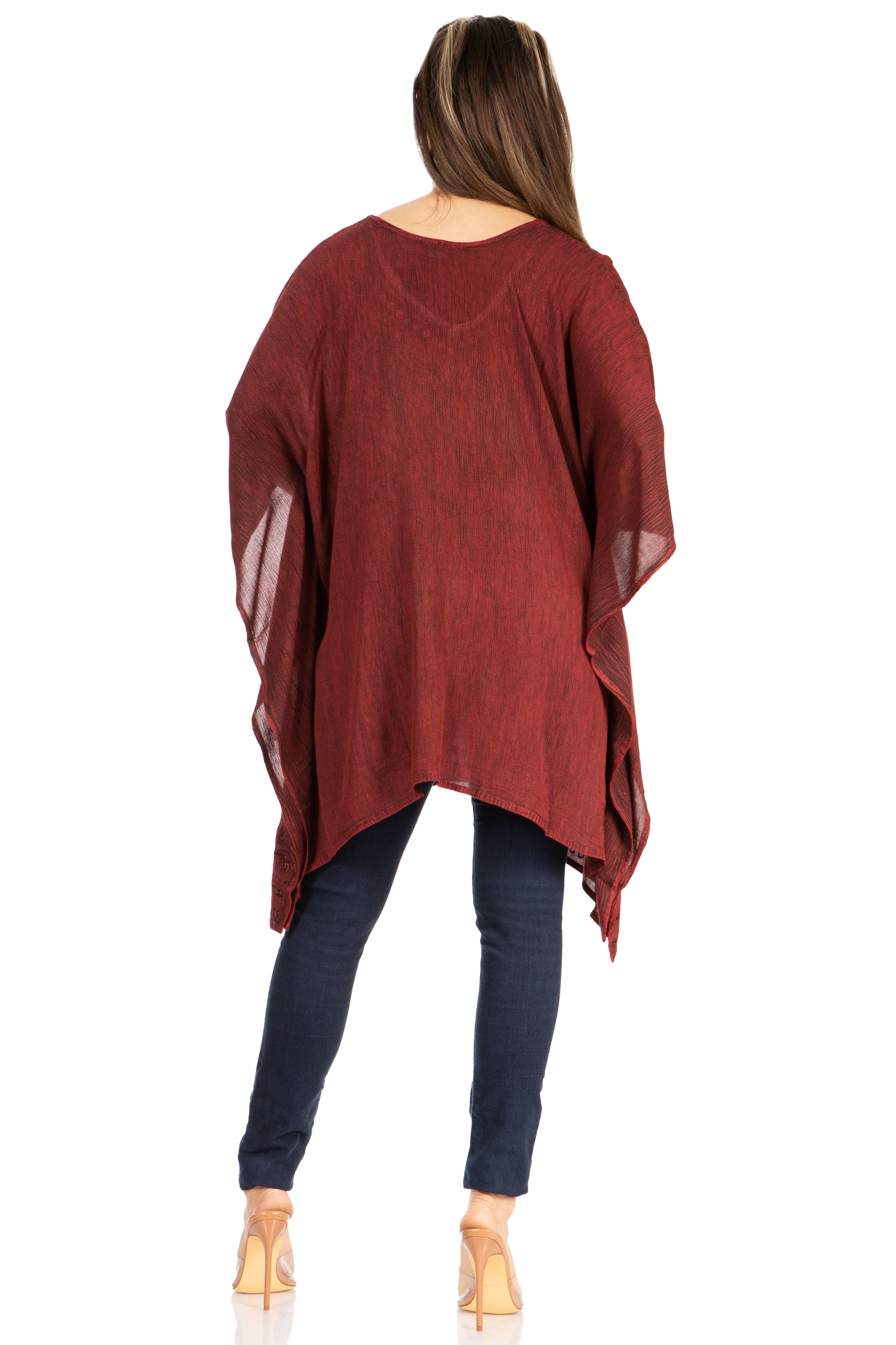 Woman wearing a red poncho over a blue outfit on a white background