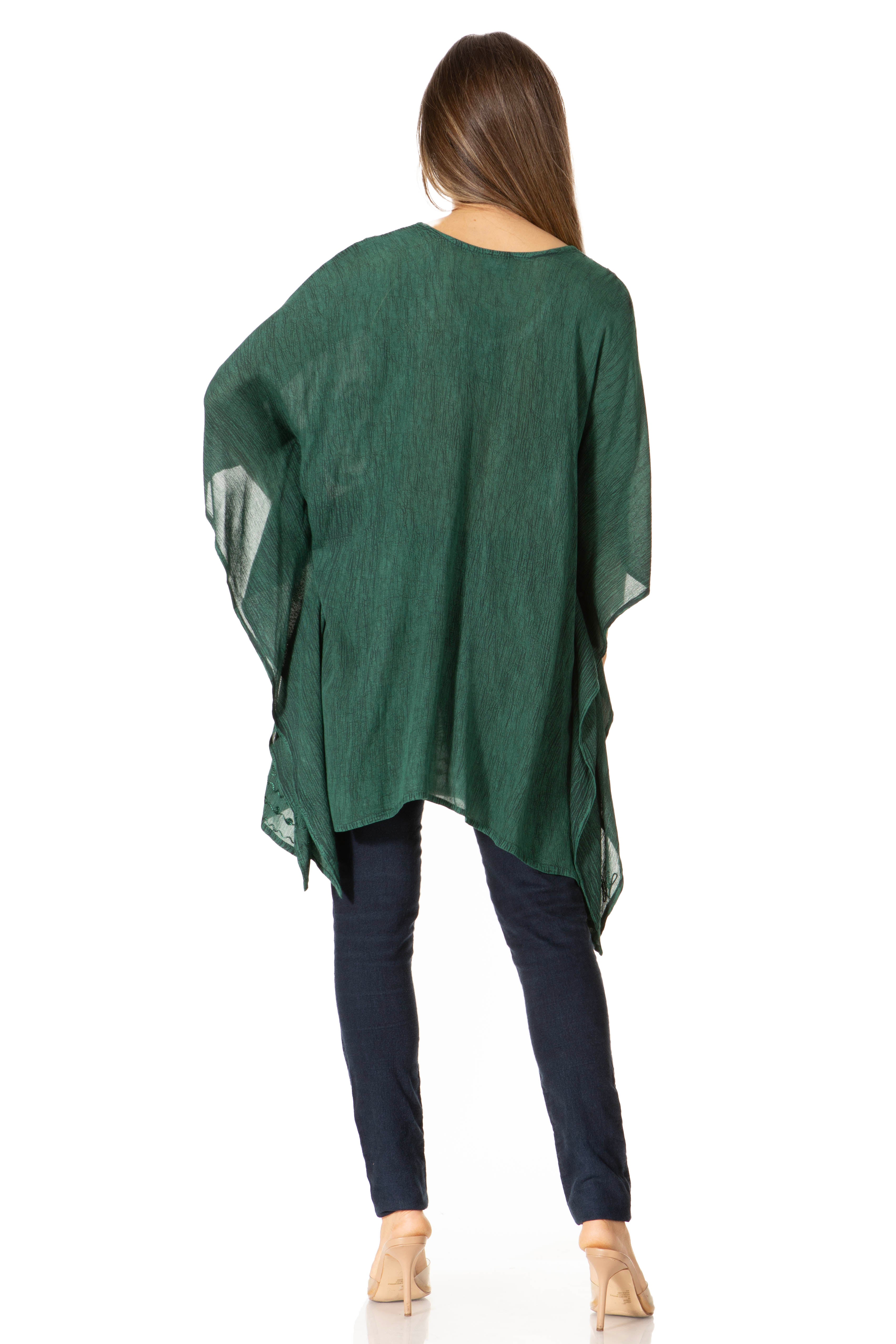 Green poncho worn by a person on a white background