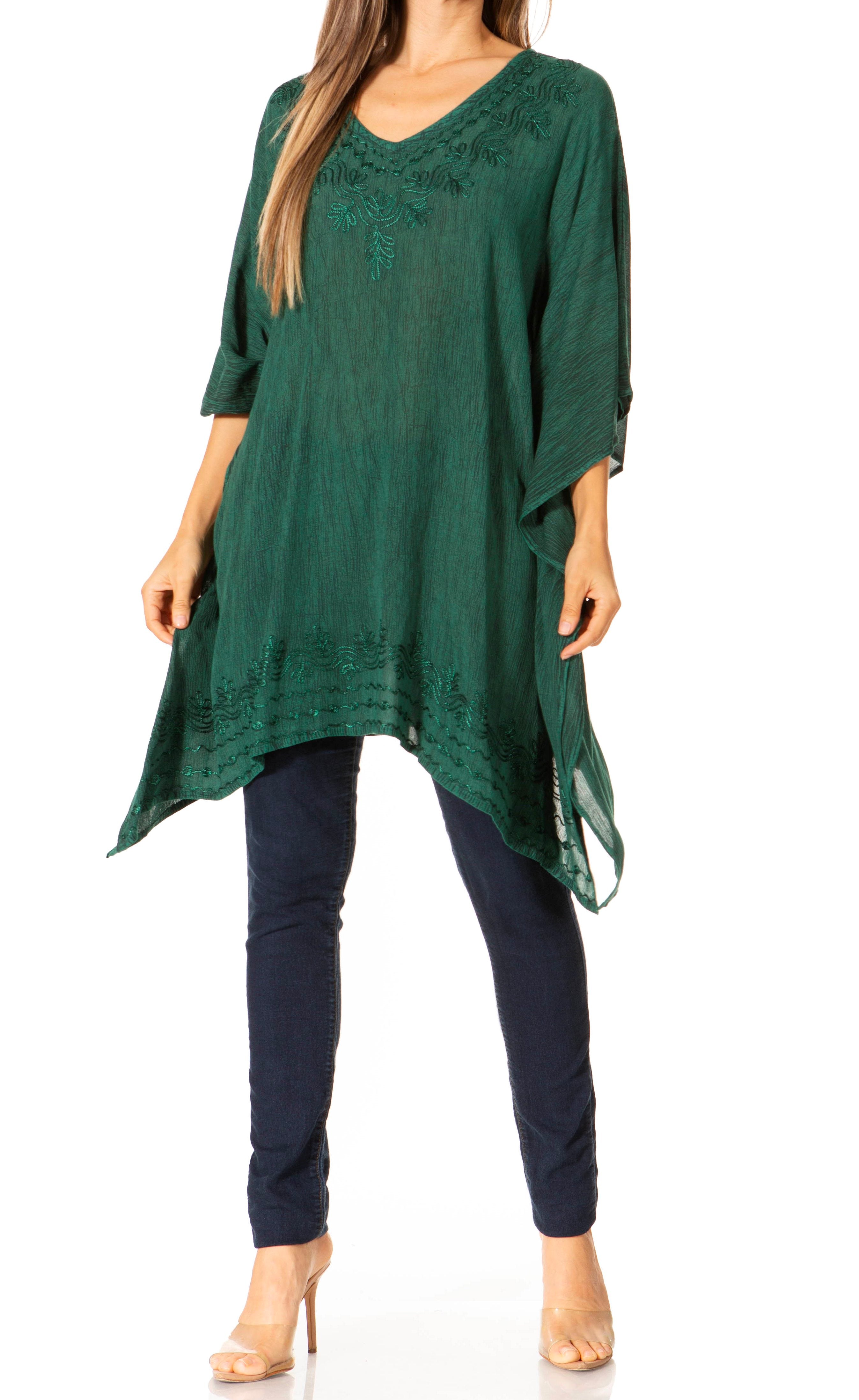 Green lace top and navy pants on a white background