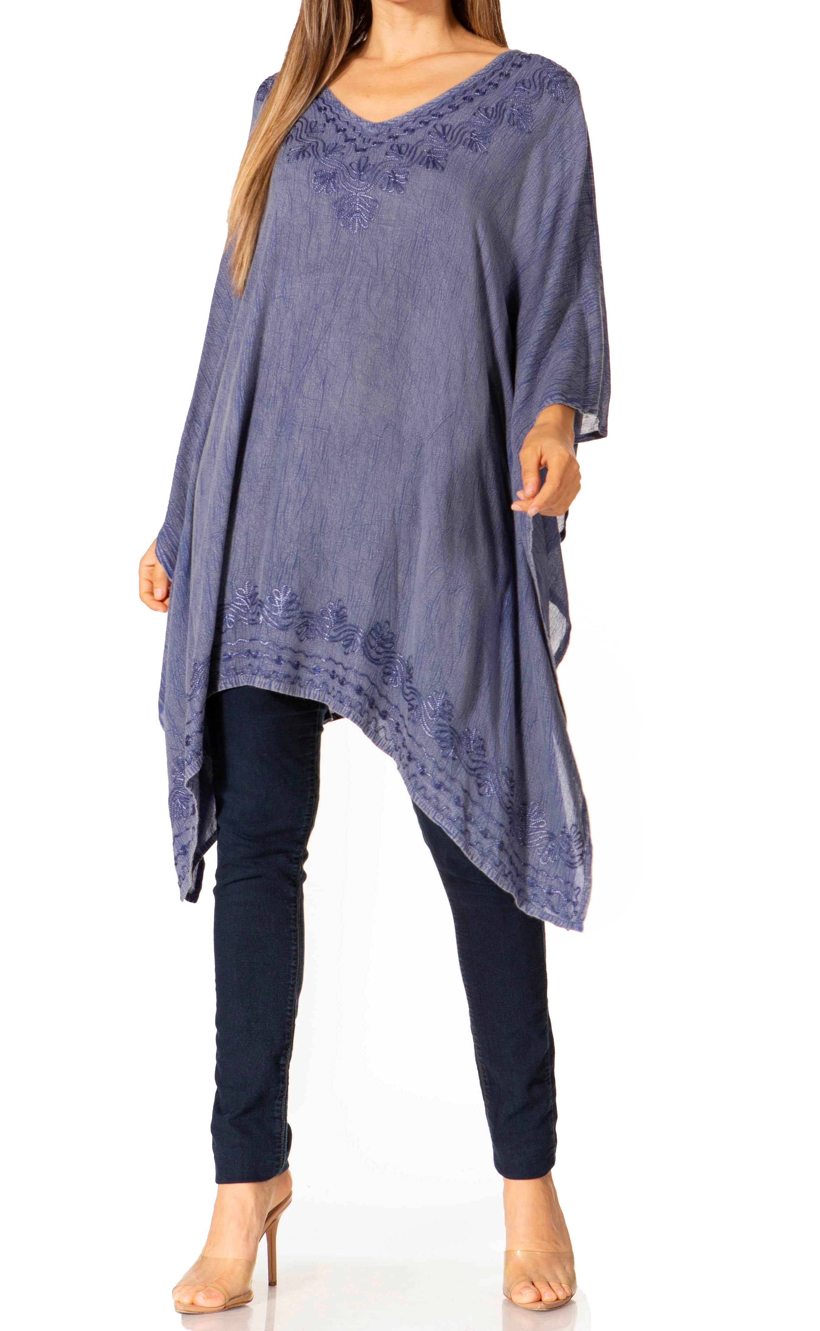 Long, flowing blue top with a V-neckline worn by a model on a white background