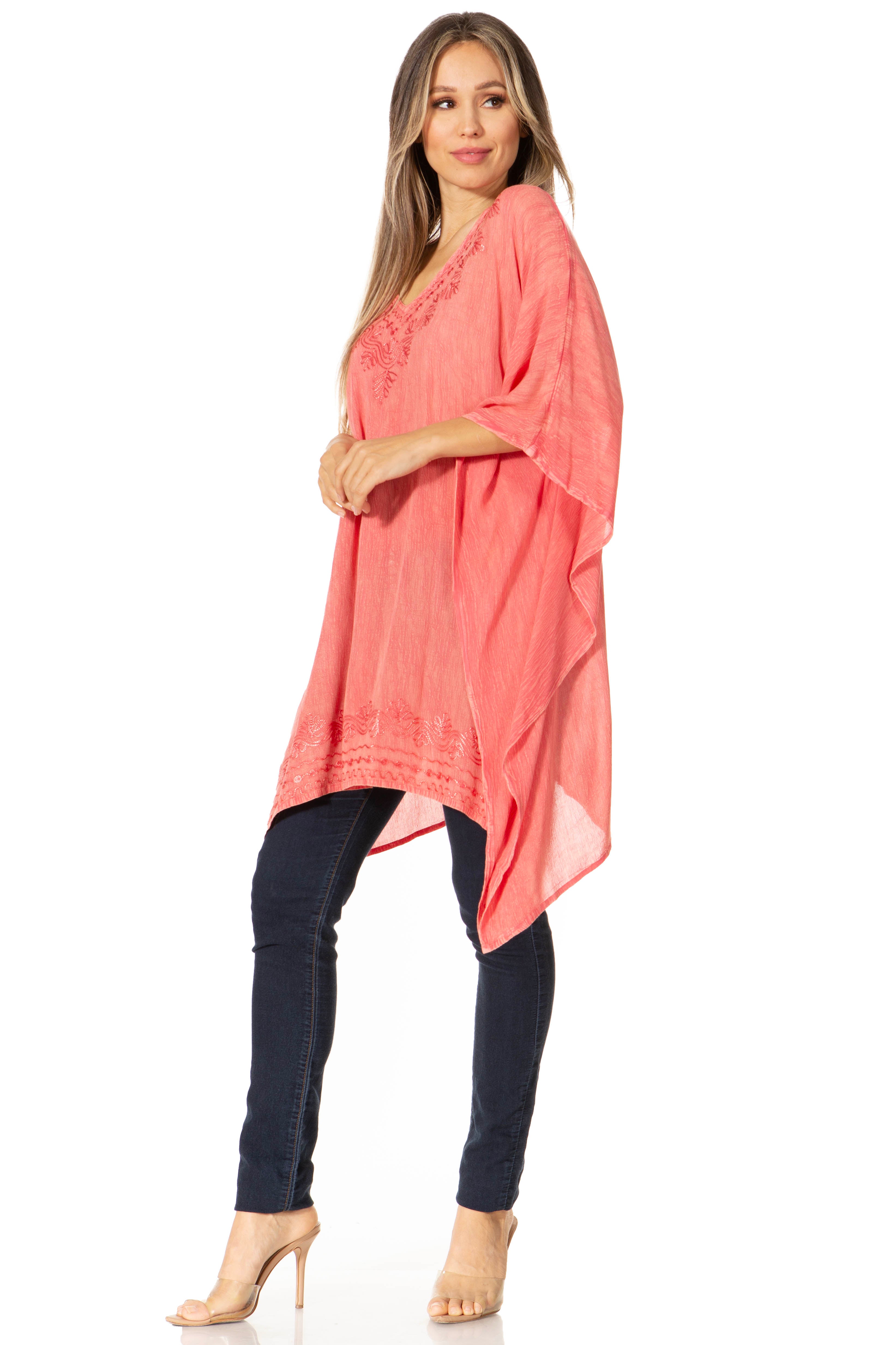Woman wearing a coral tunic and black pants on a white background
