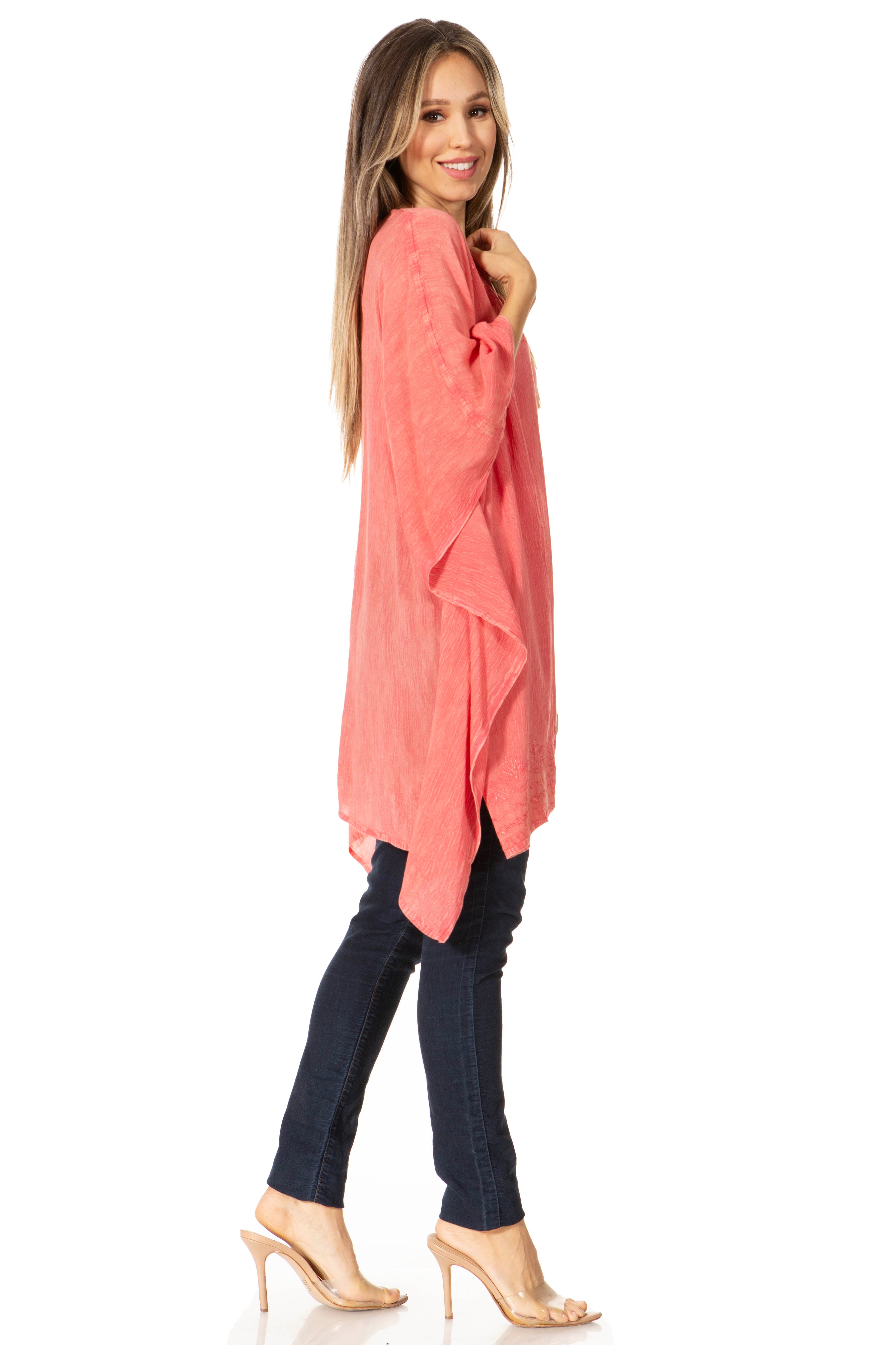 Woman wearing a coral oversized shirt and dark jeans on a white background