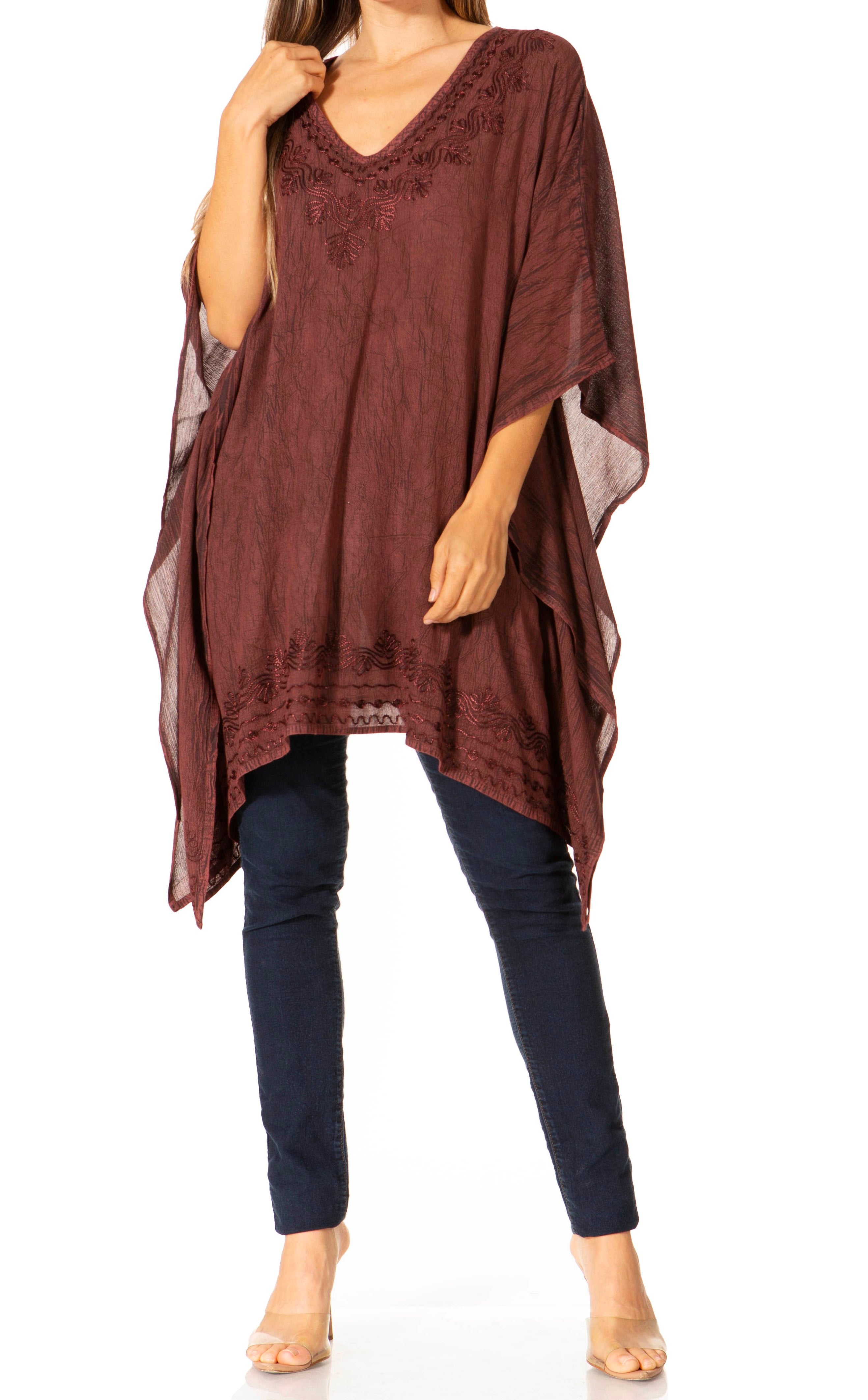 Brown poncho over a dark blue outfit on a white background