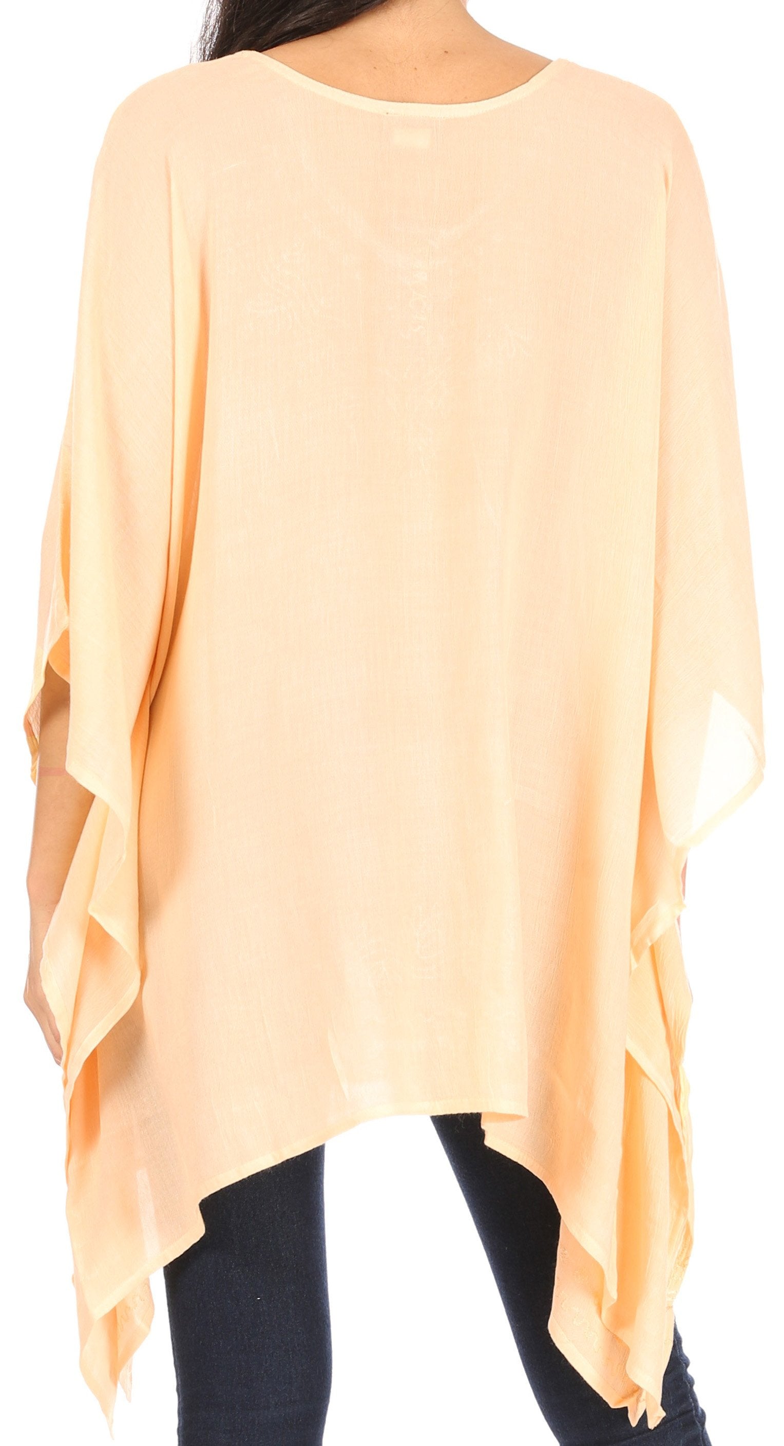Light peach poncho worn by a person on a white background