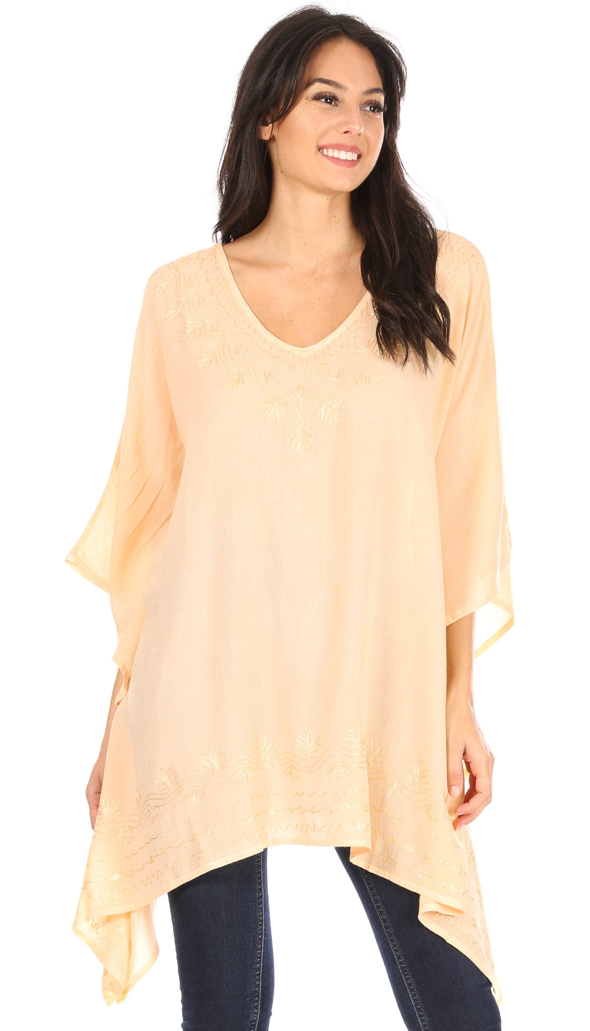 Woman wearing a light peach poncho over a white background