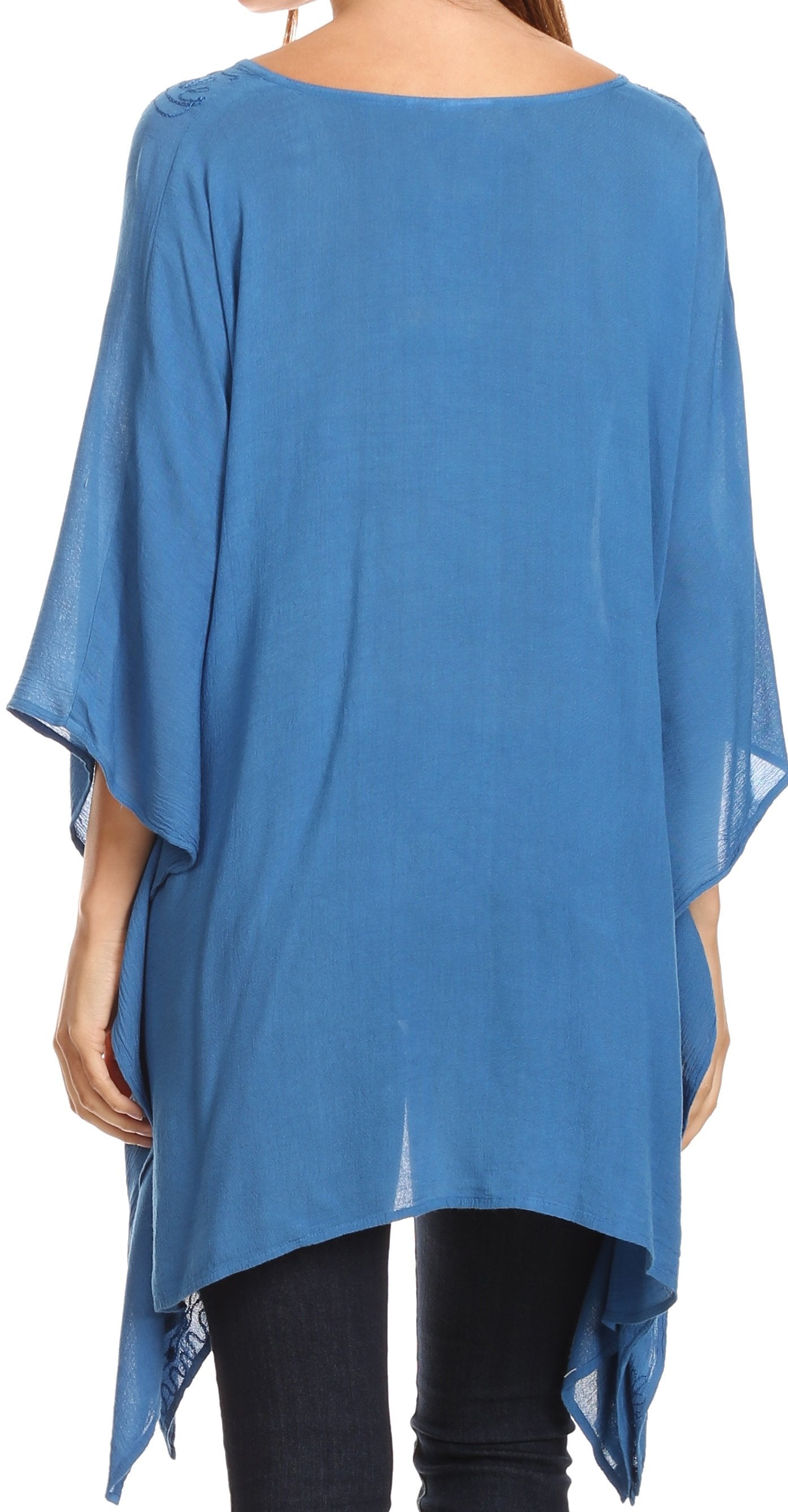 Blue poncho-style top worn by a person on a white background