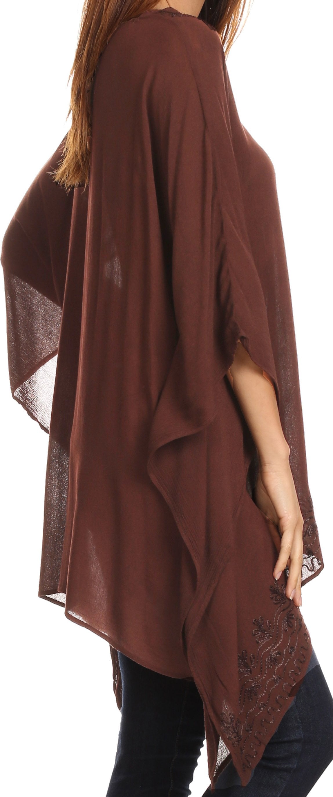 Brown poncho with lace details on a white background