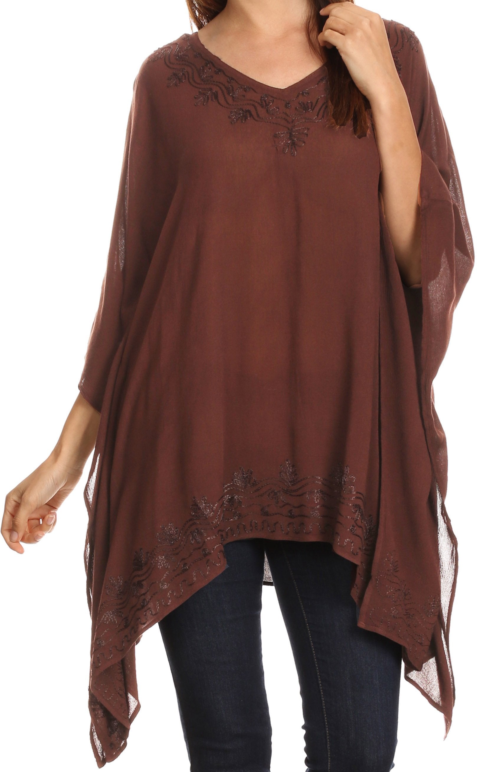 Brown poncho with lace details worn by a person on a white background