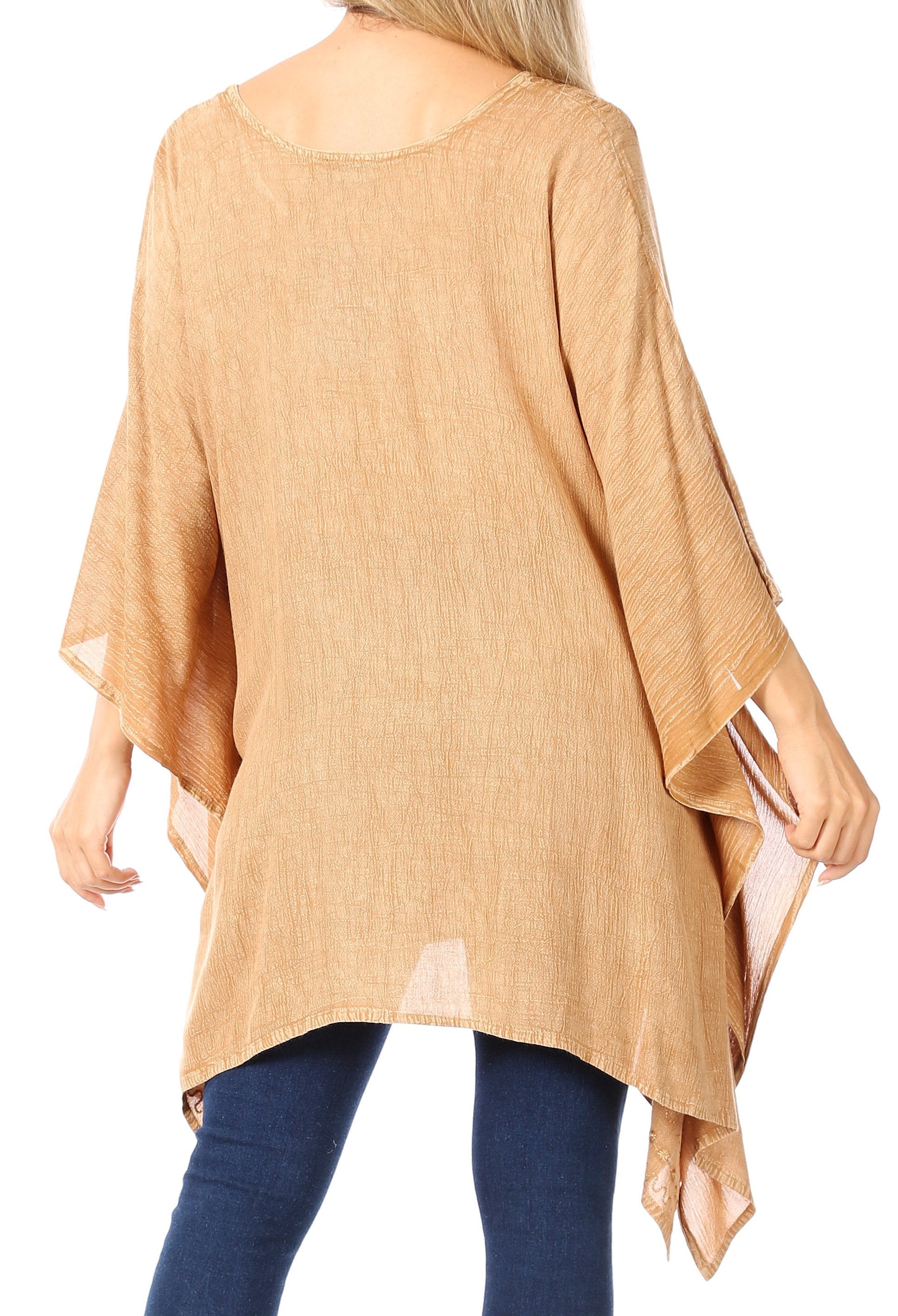 Beige poncho worn by a person on a white background