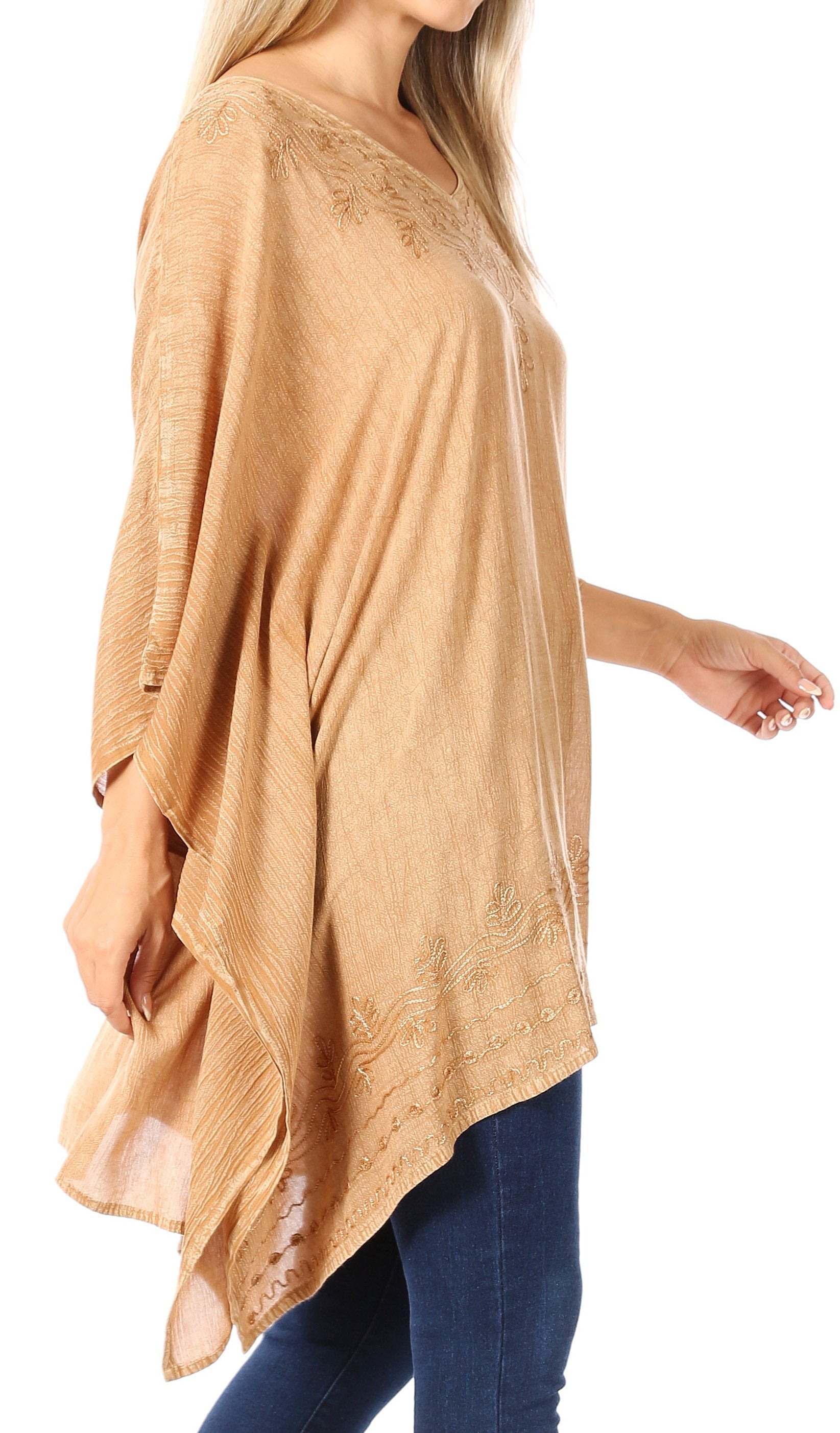 Woman wearing a beige lace-trimmed top with a white background