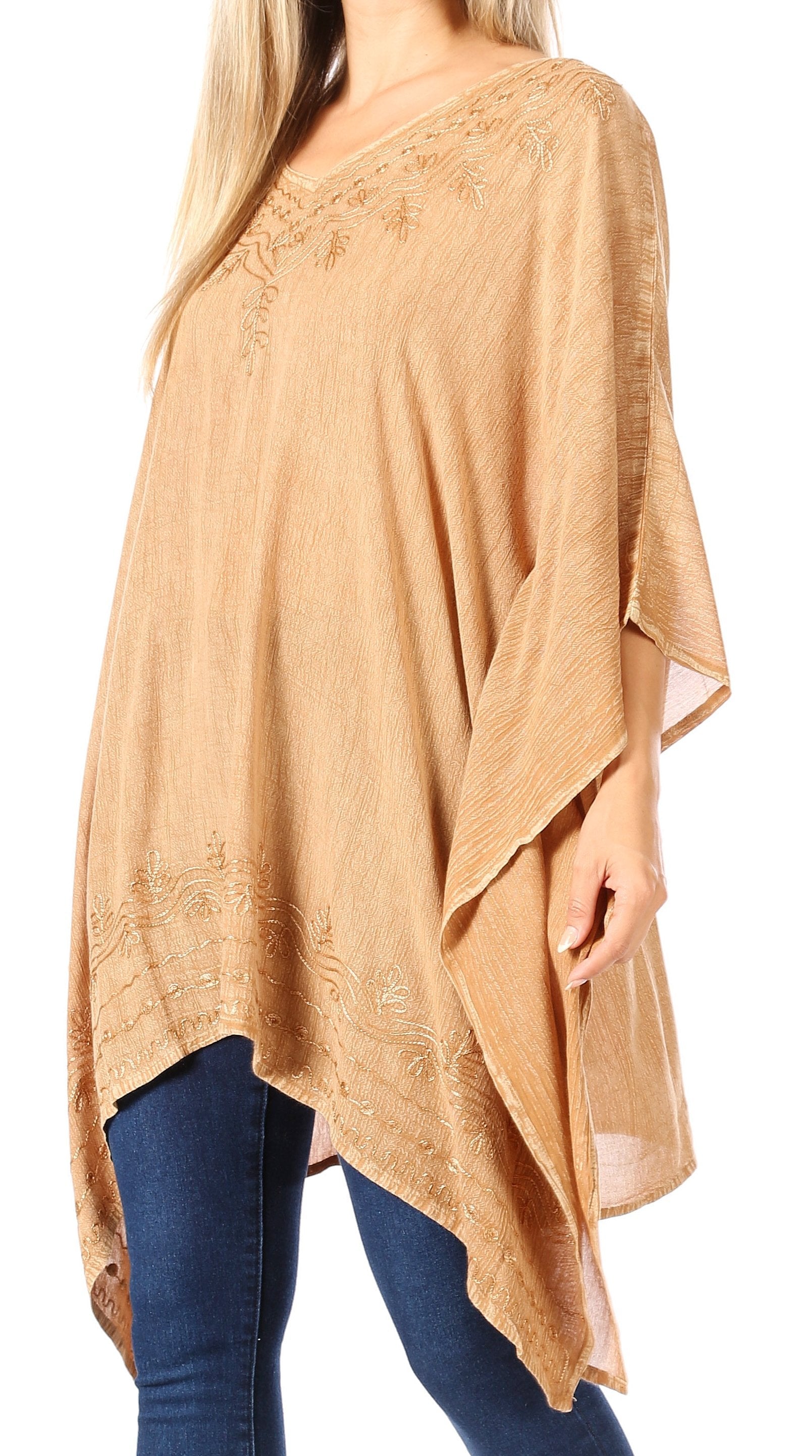 Beige poncho with lace details worn by a person on a white background