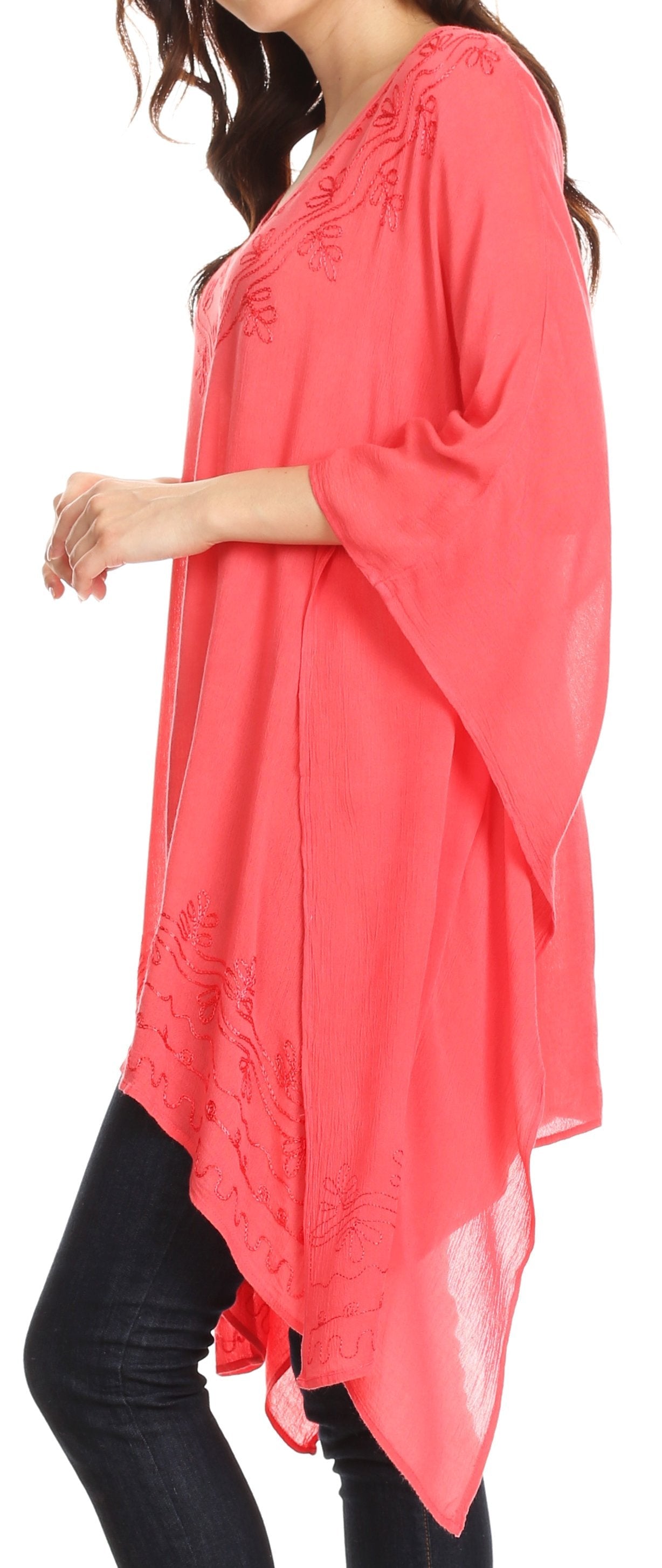 Coral poncho worn by a person on a white background