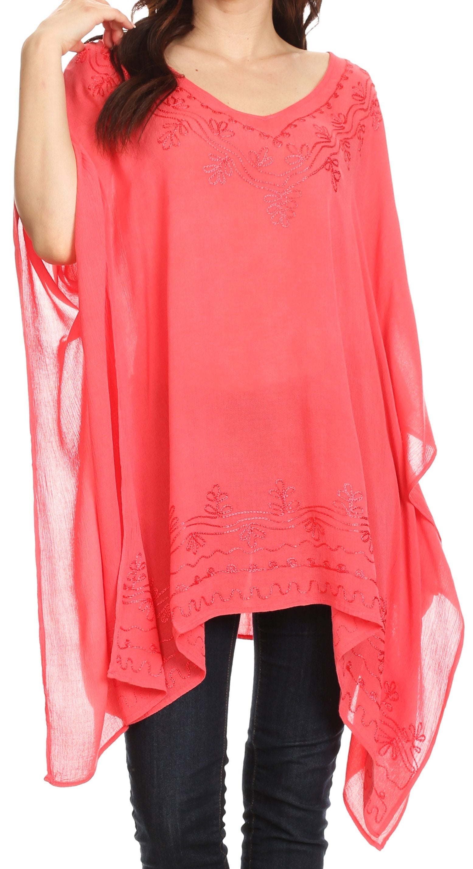 Coral sheer top with black pants on a white background