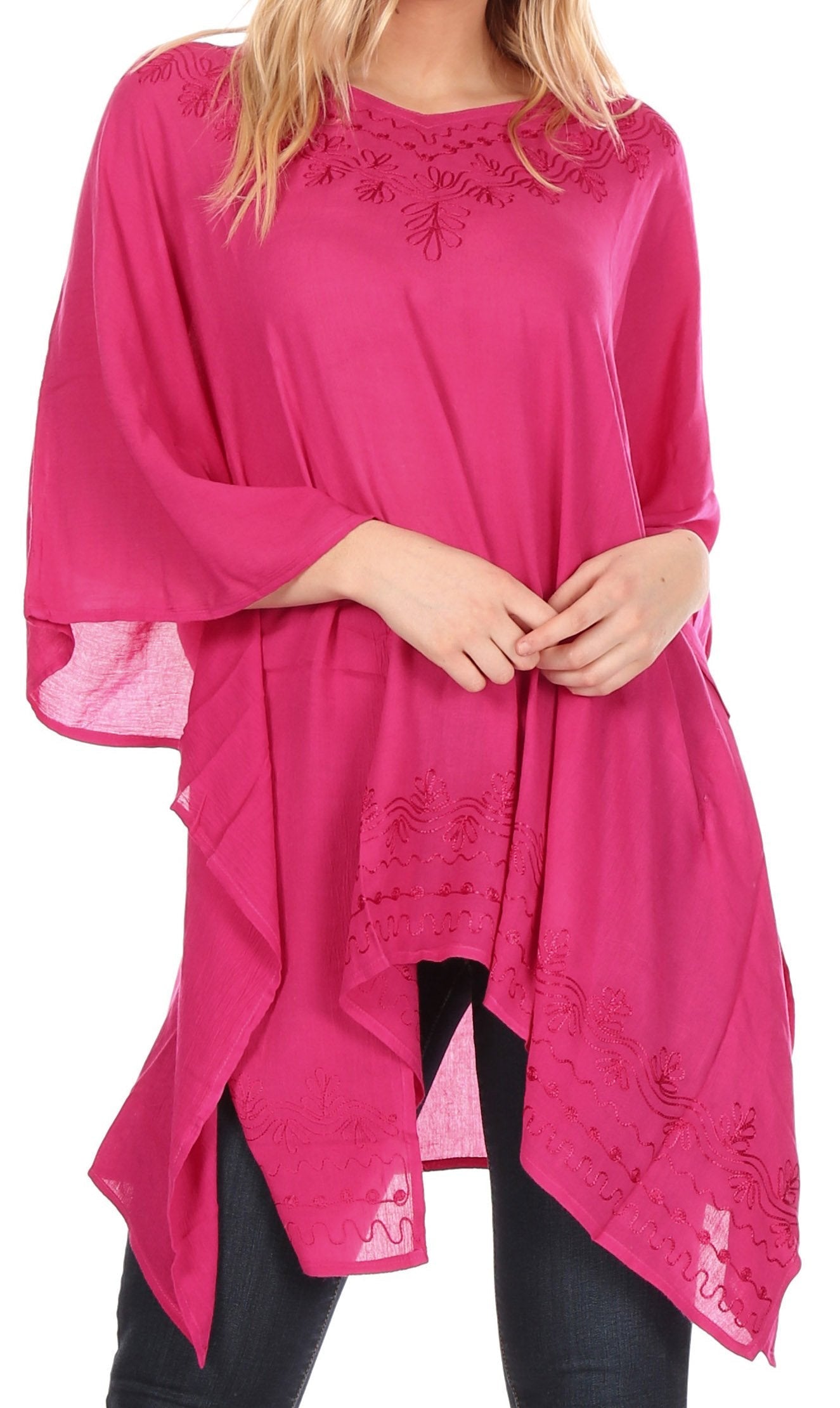 Pink poncho with lace details worn by a person on a white background