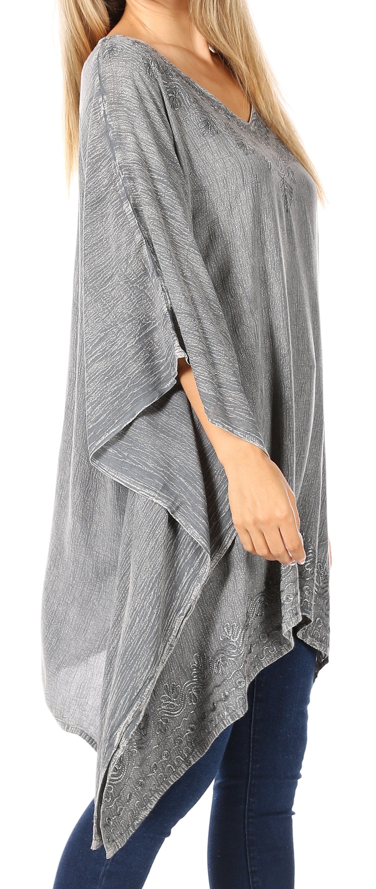 Gray poncho worn by a person on a white background