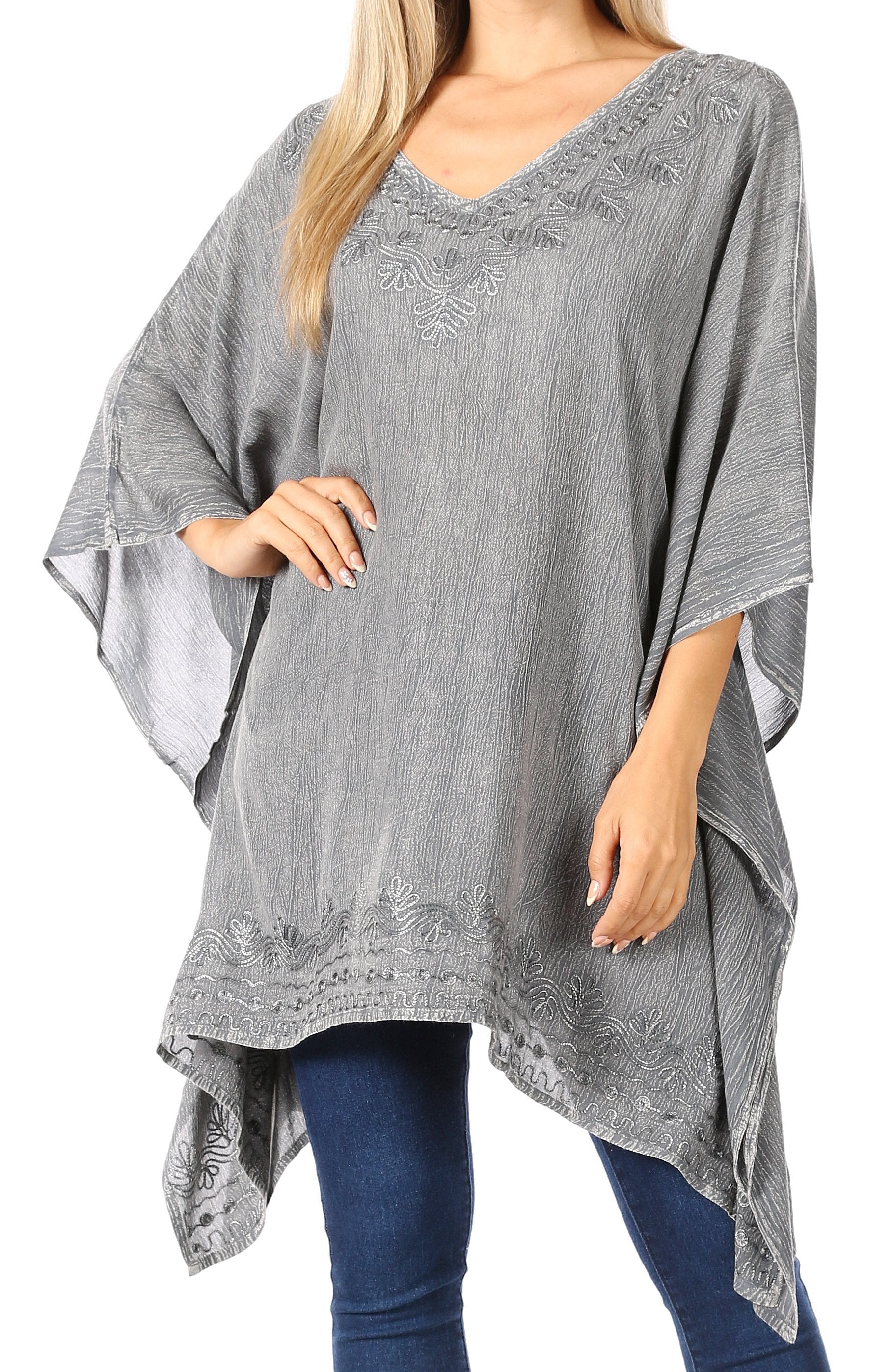 Gray poncho worn by a person on a white background