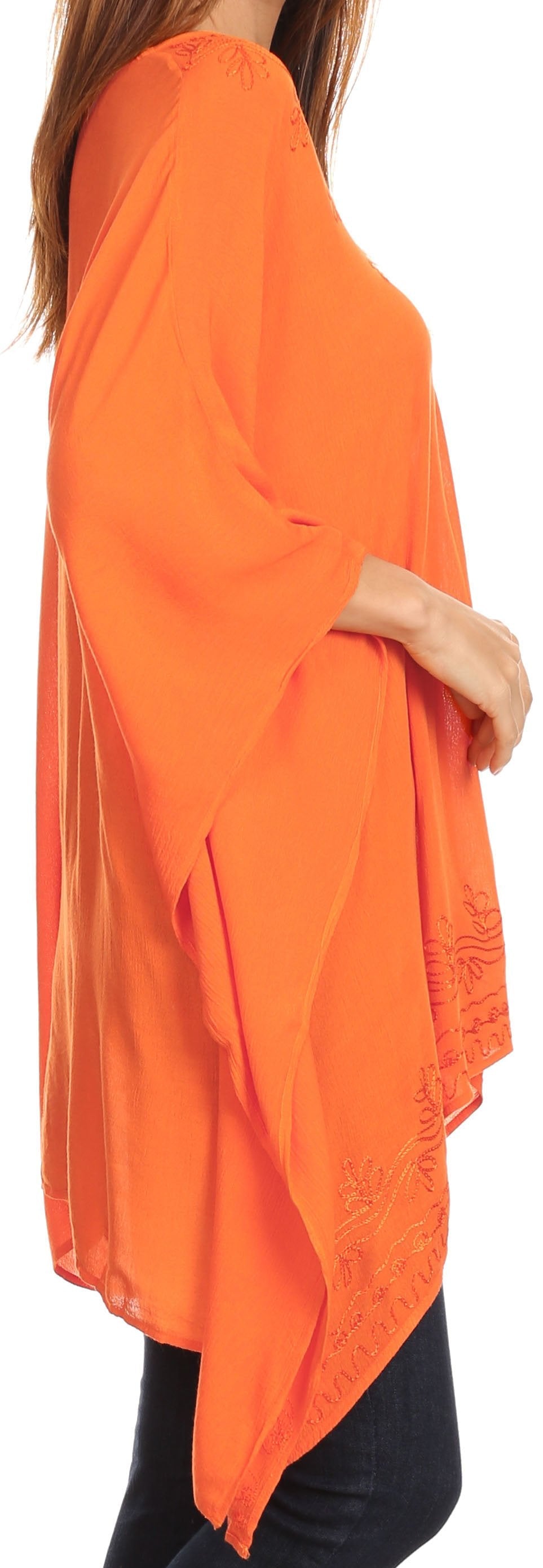 Orange poncho worn by a person, with a focus on the garment.