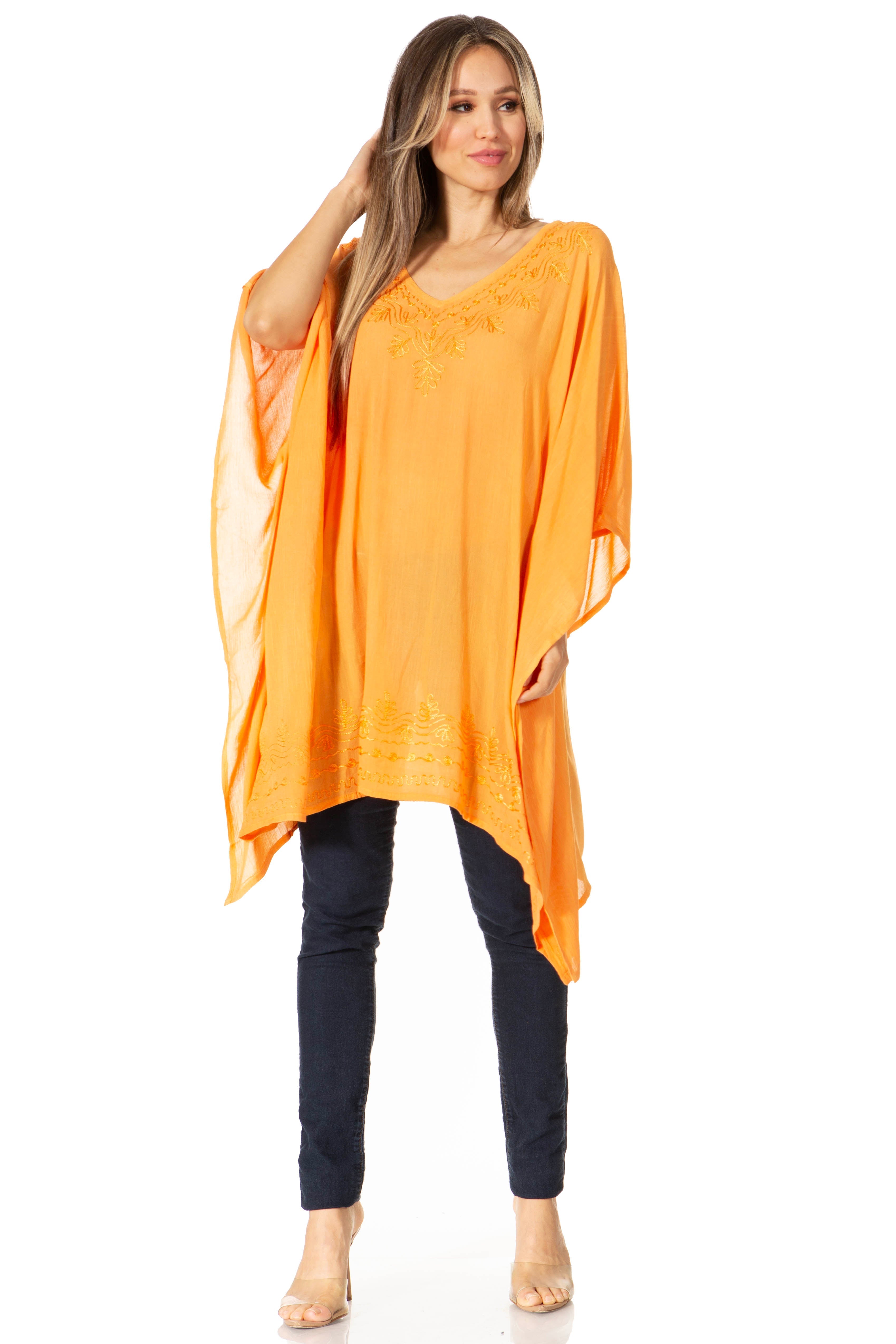 Woman wearing an orange long top with a white background