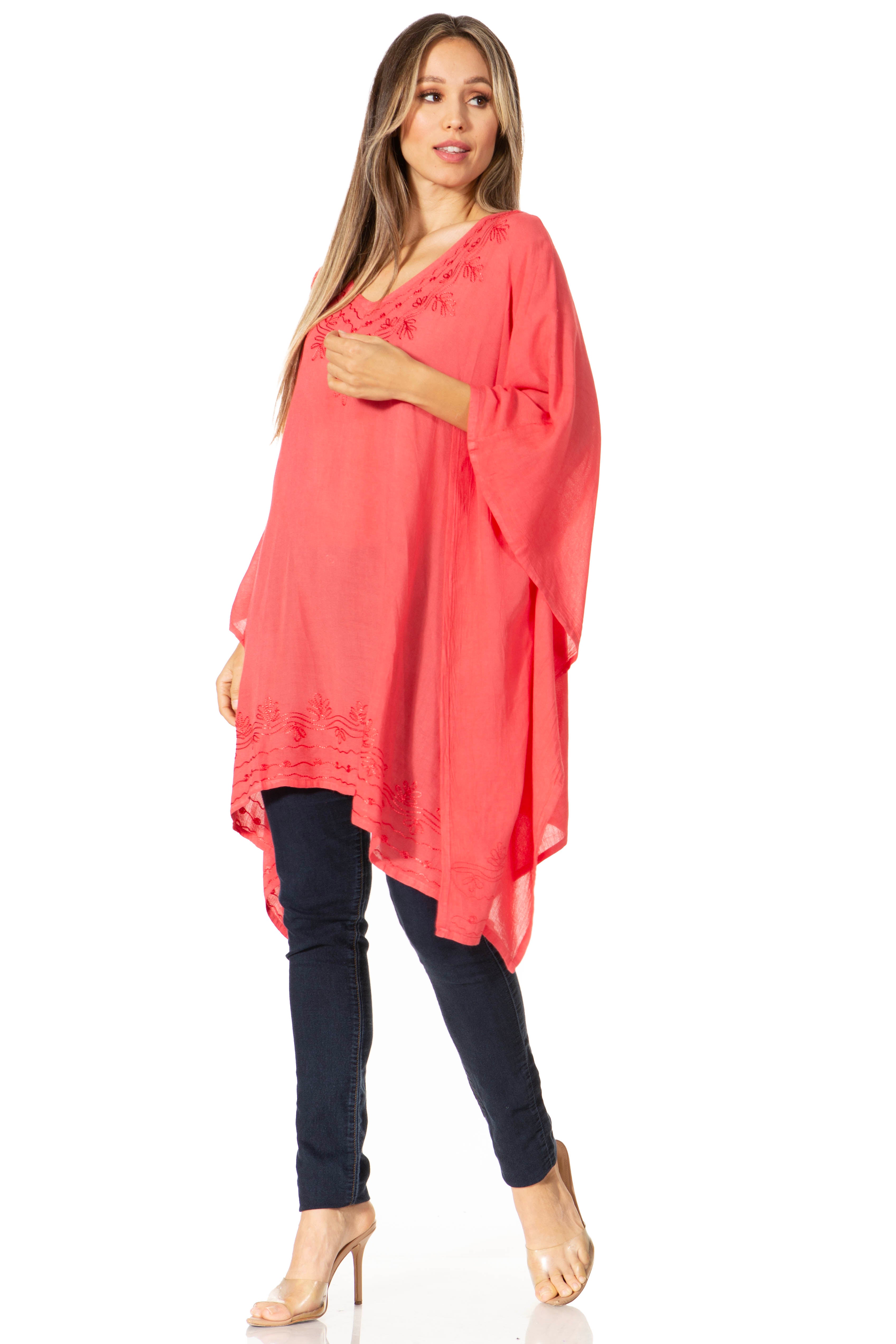 Woman wearing a coral tunic and black pants on a white background