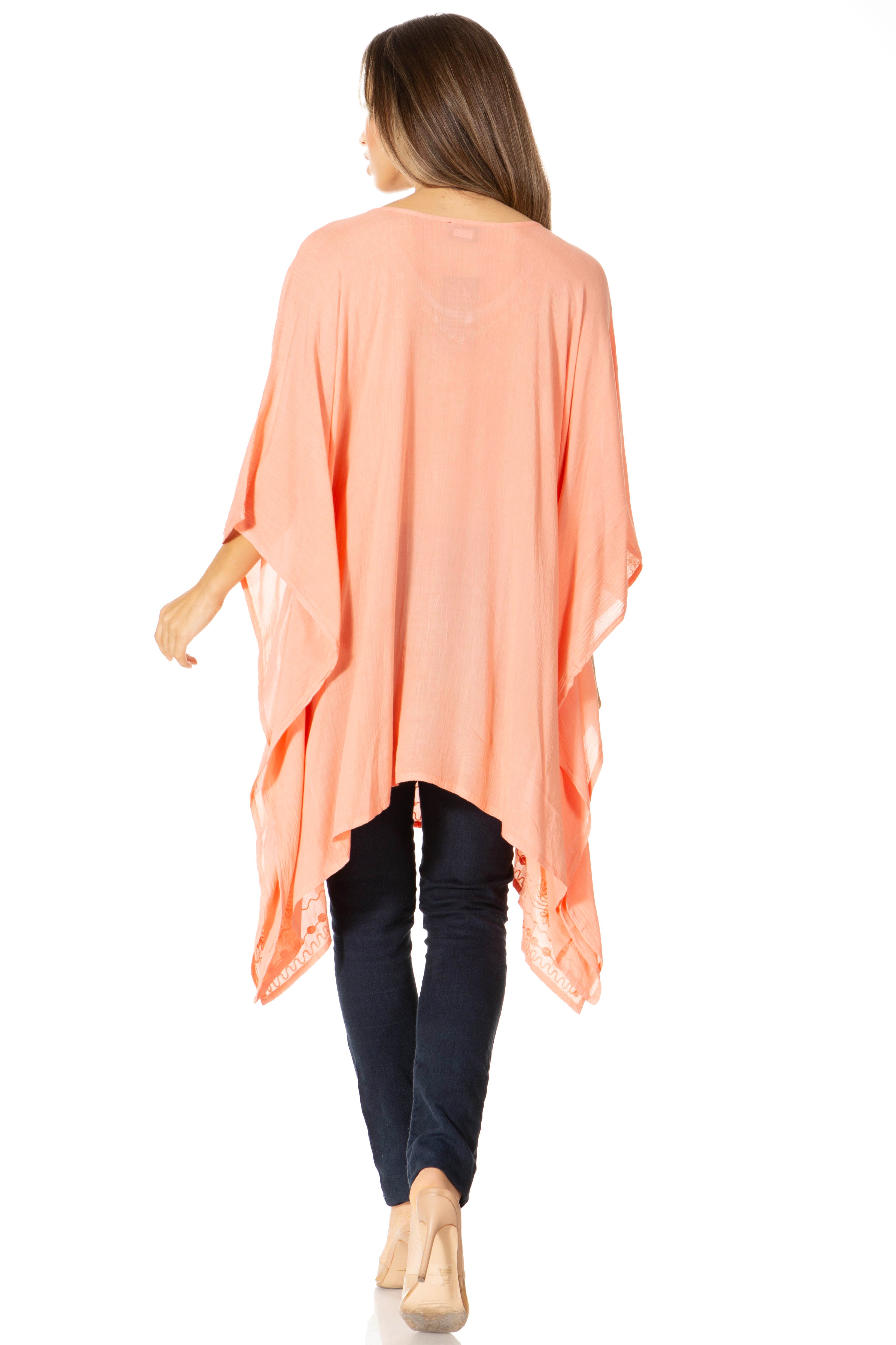 Woman wearing a peach-colored kimono-style garment on a white background