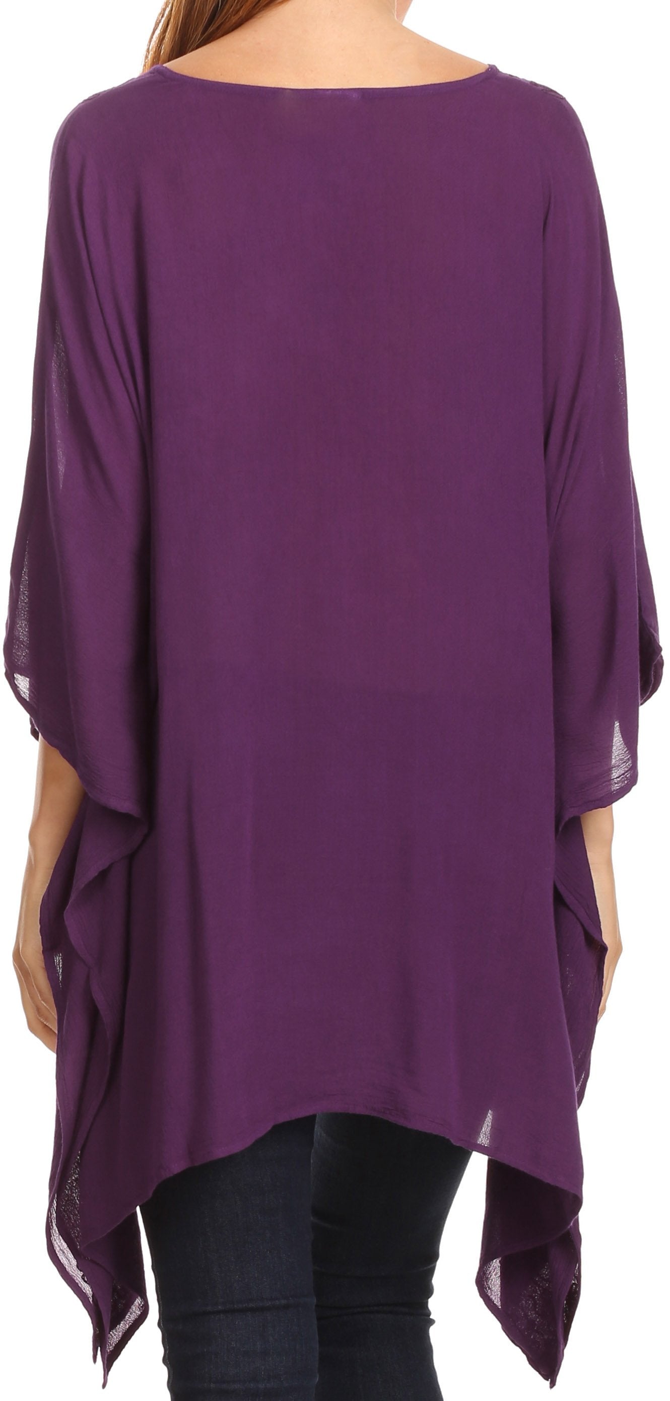 Purple flowing top worn by a person on a white background