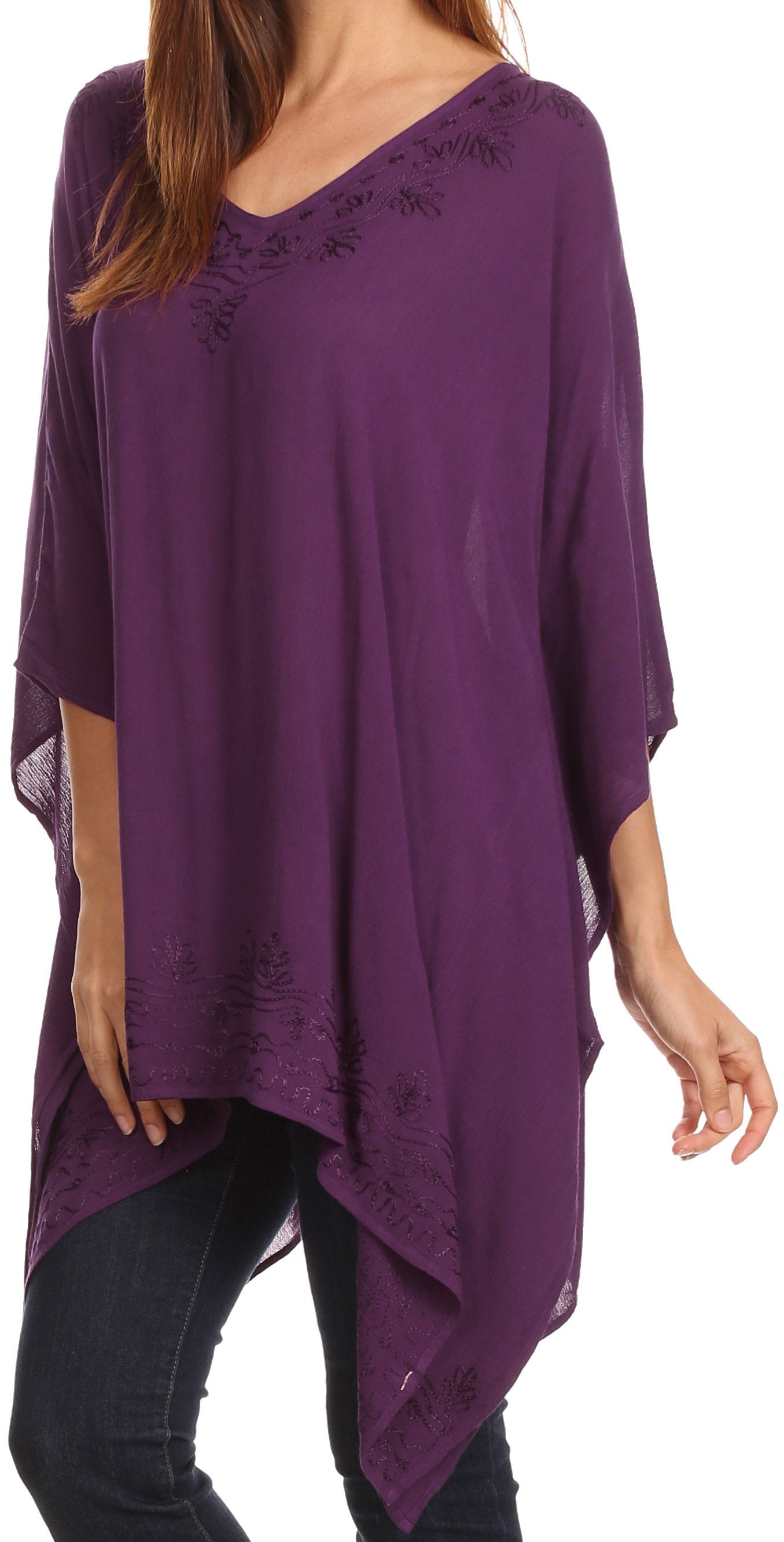 Purple poncho with lace details worn by a person on a white background