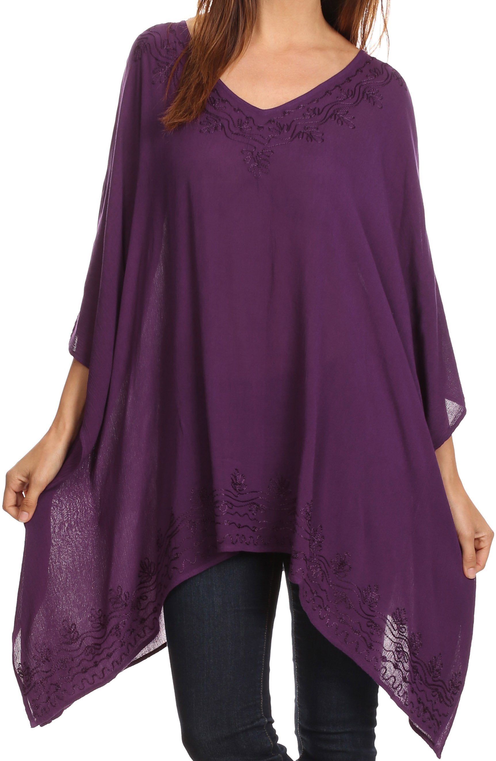 Purple poncho with lace details worn by a person on a white background