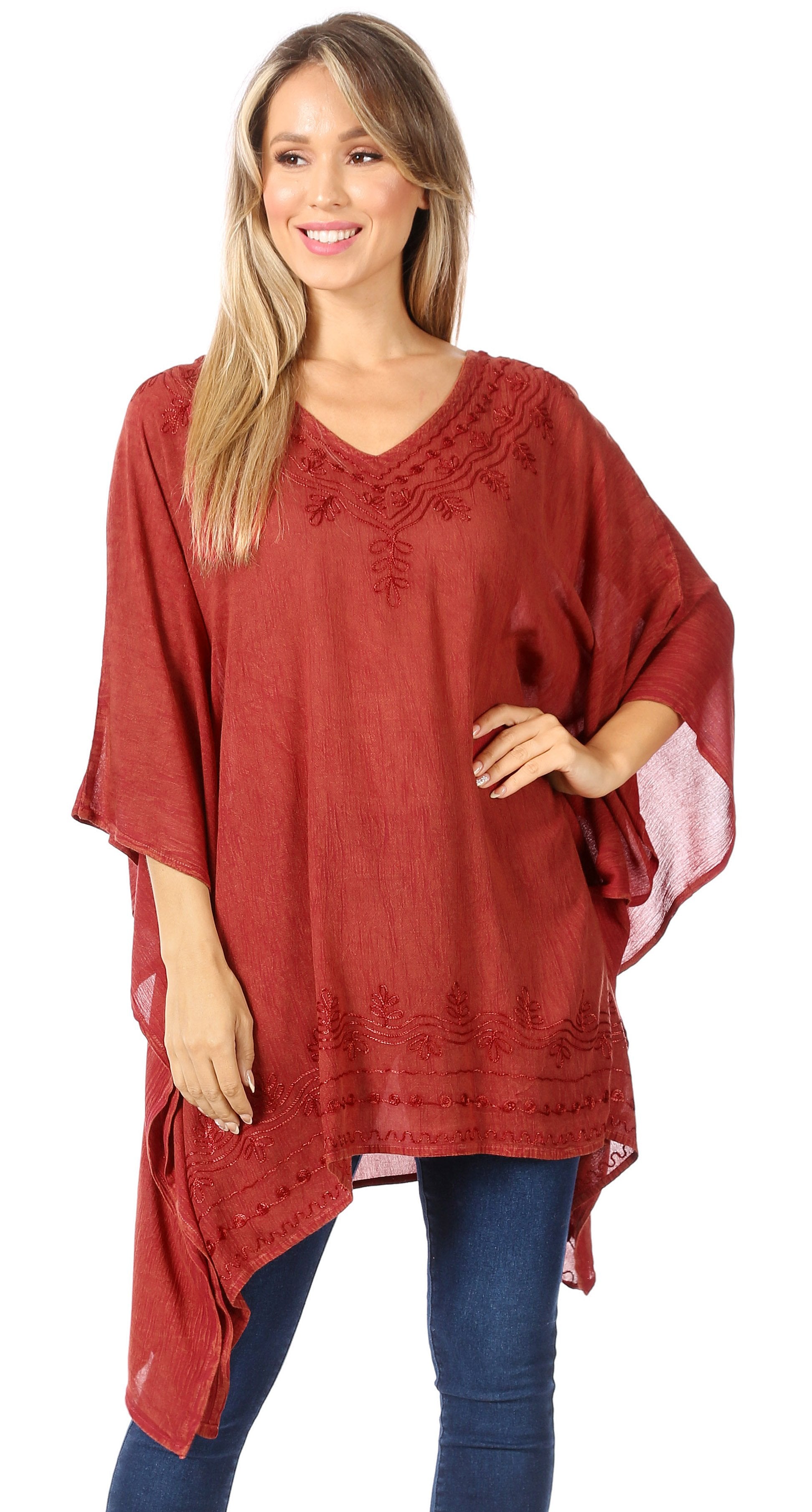 Woman wearing a red poncho with lace details on a white background