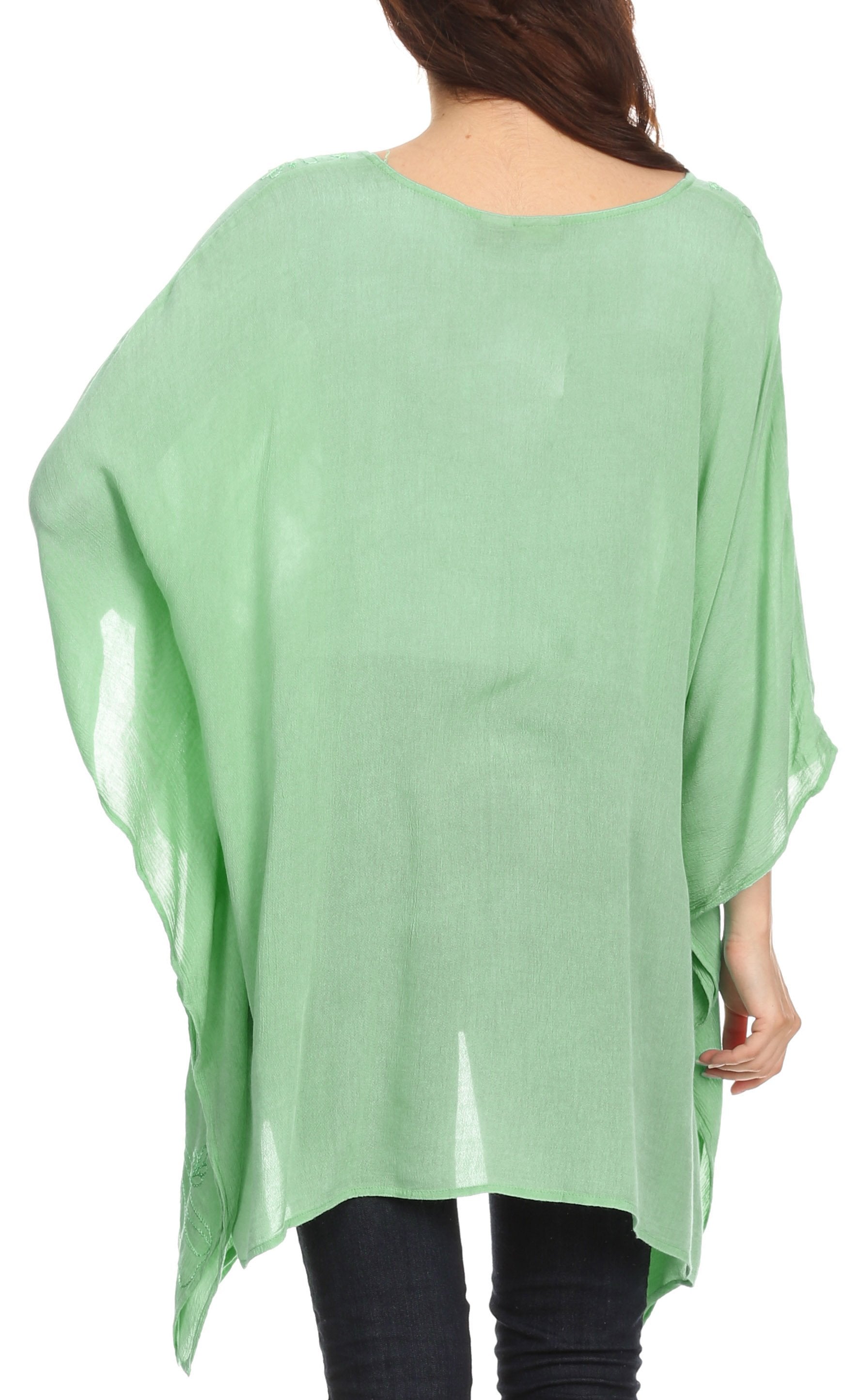 Light green poncho worn by a person on a white background