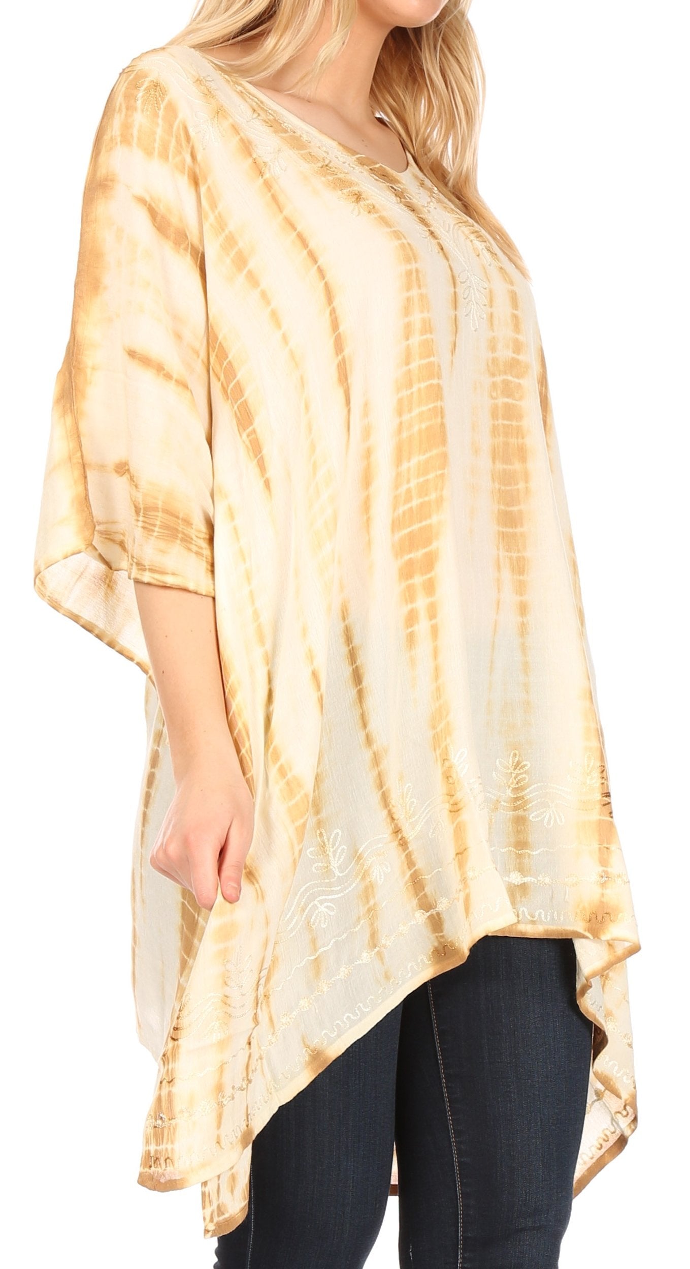 Woman wearing a tie-dye beige and brown top with black pants on a white background
