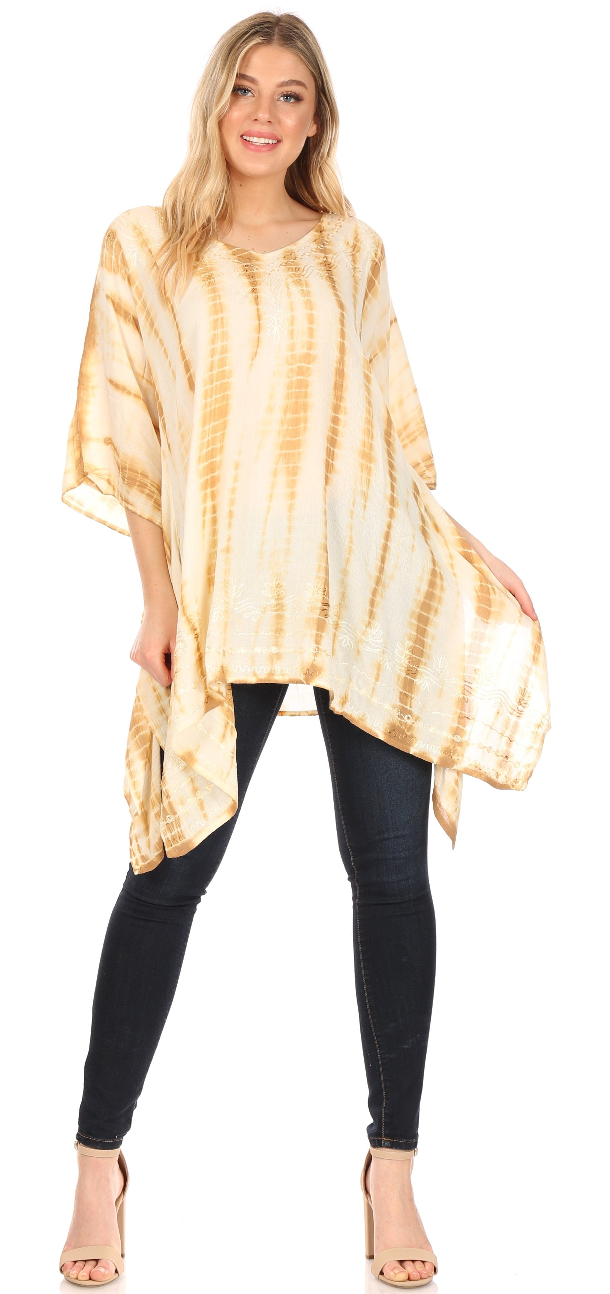 Woman wearing a tie-dye poncho over black leggings on a white background