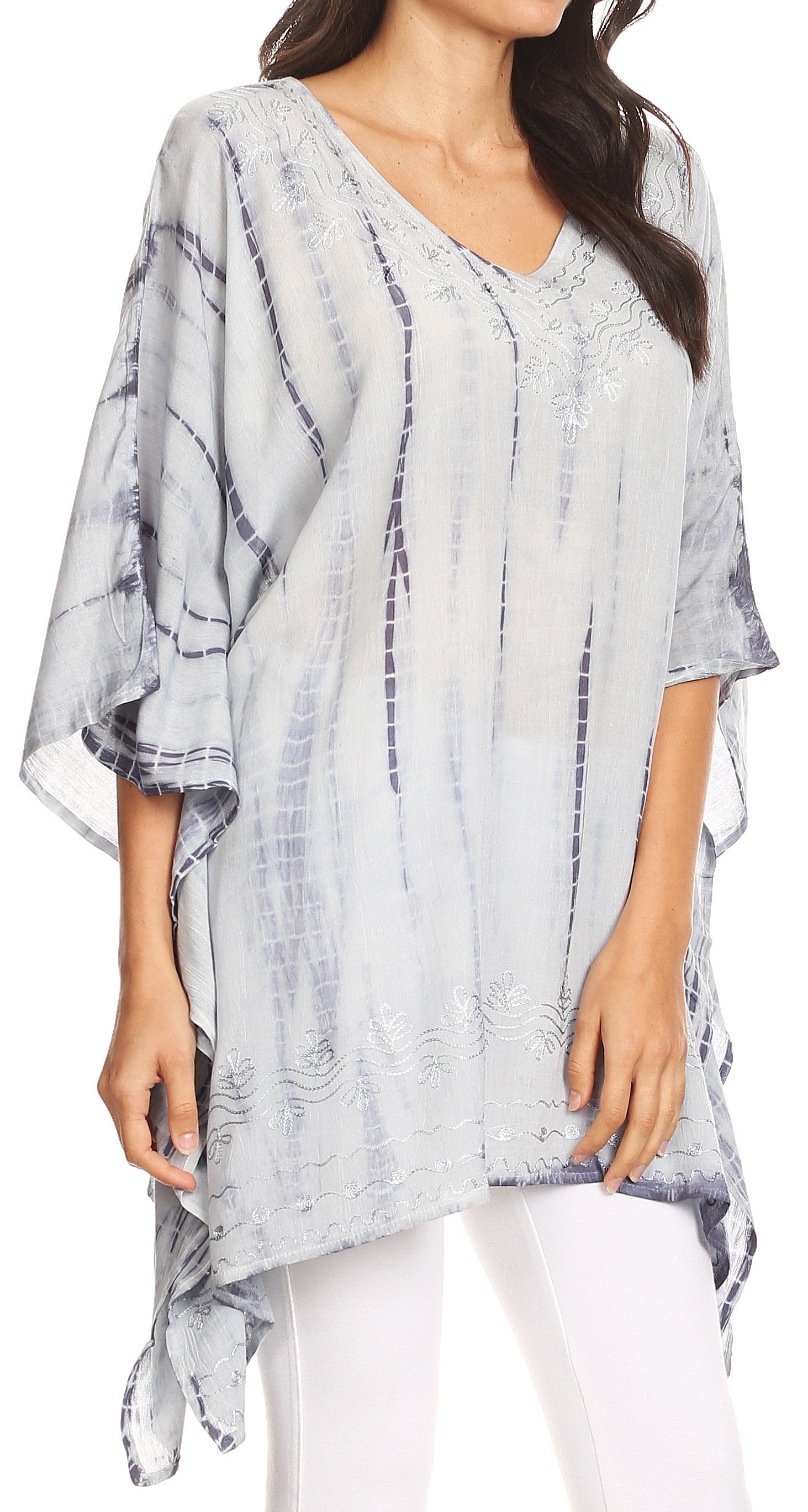 Woman wearing a light blue and white patterned kimono-style top with white pants.