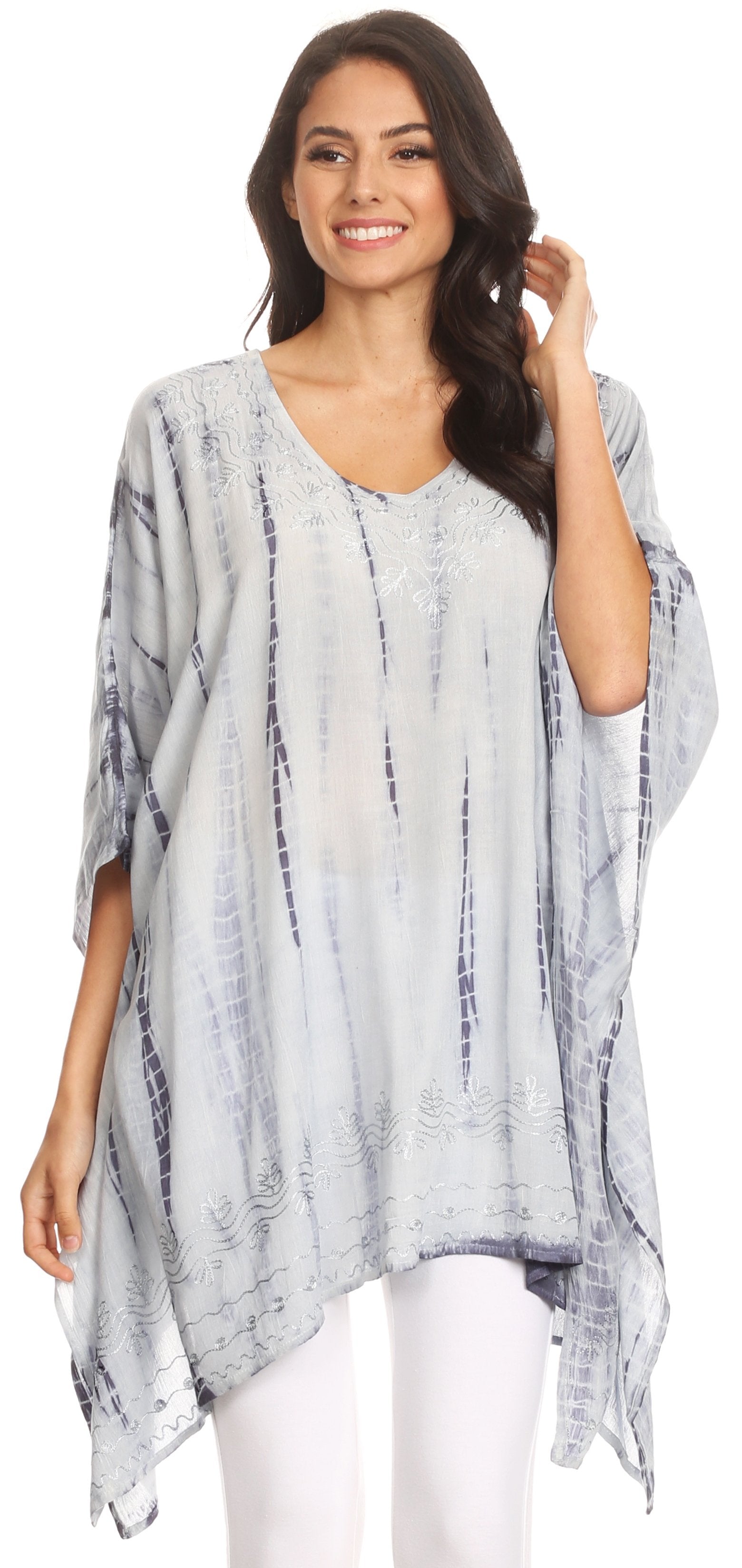 Woman wearing a light blue and white patterned poncho on a white background