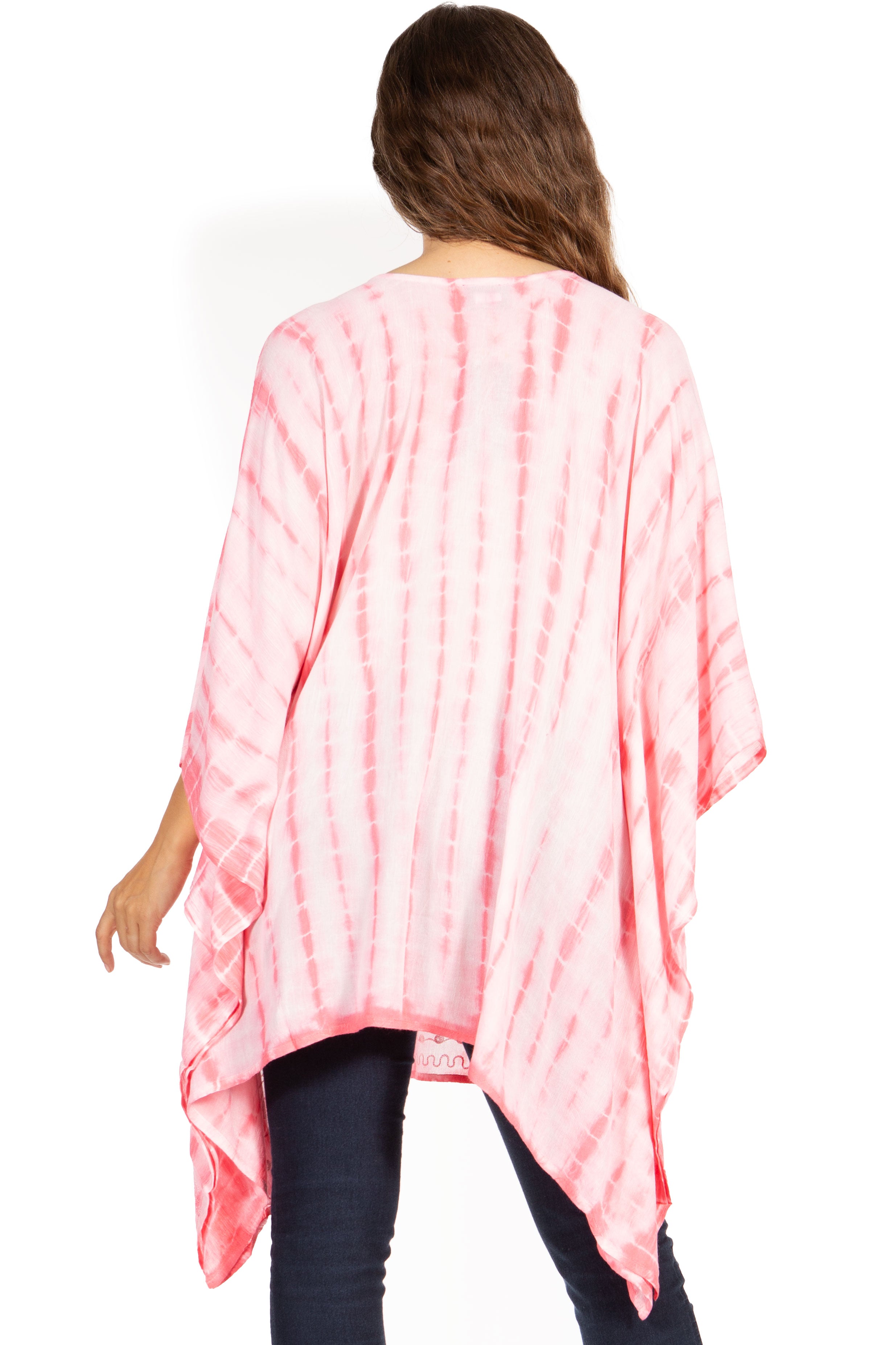 Person wearing a pink tie-dye poncho on a white background
