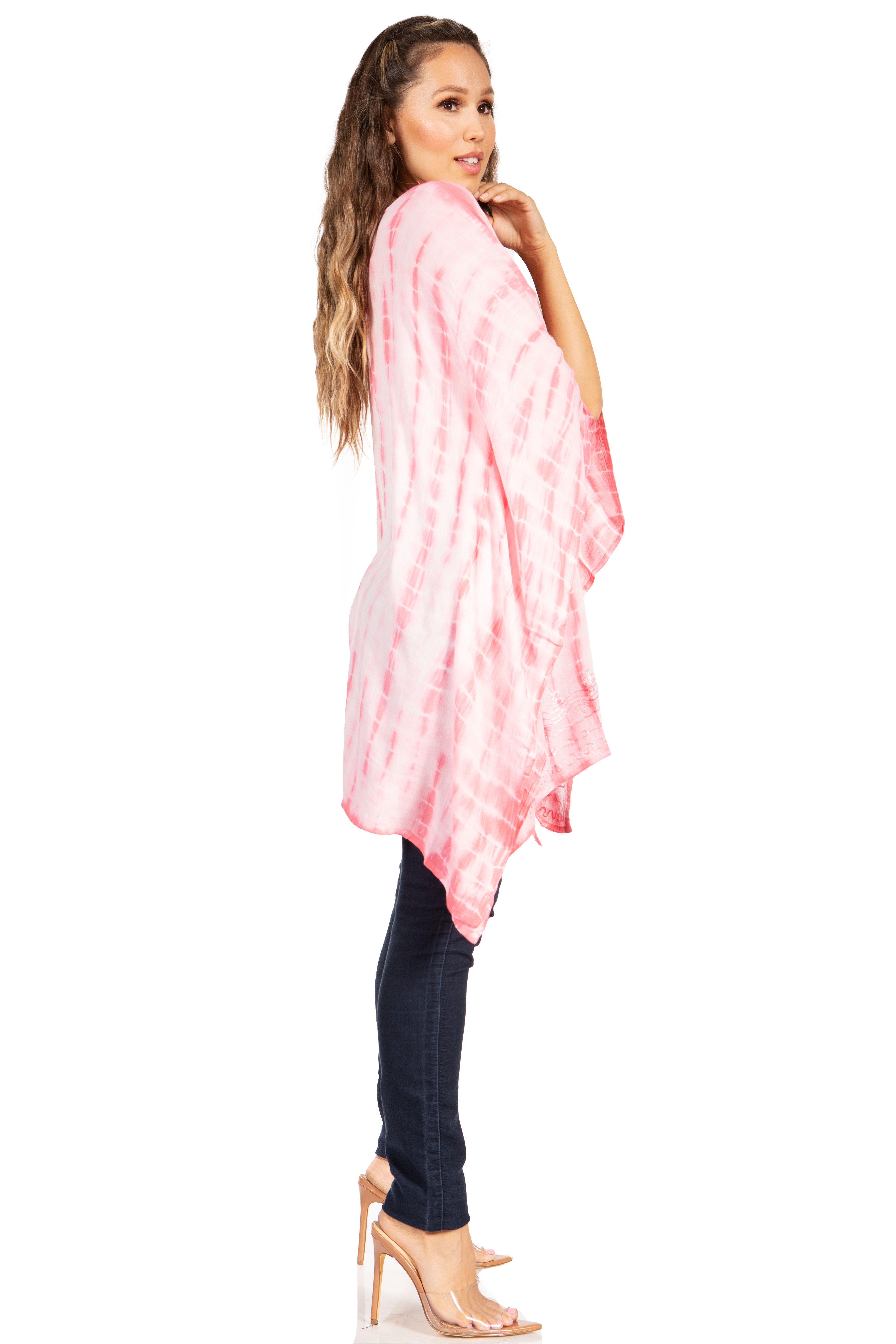 Woman wearing a pink tie-dye kimono over a black top on a white background