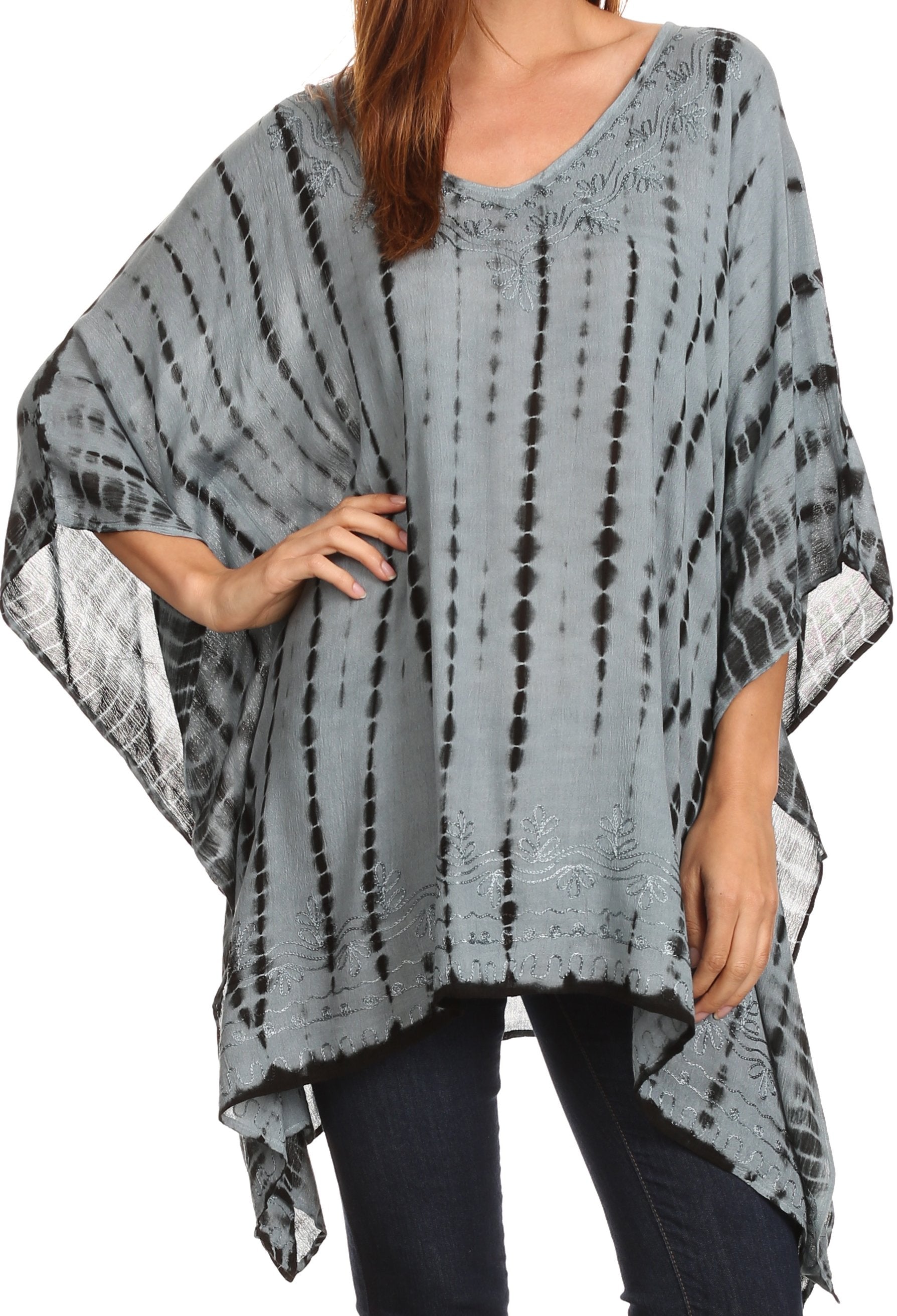 Person wearing a tie-dye poncho with a plain background
