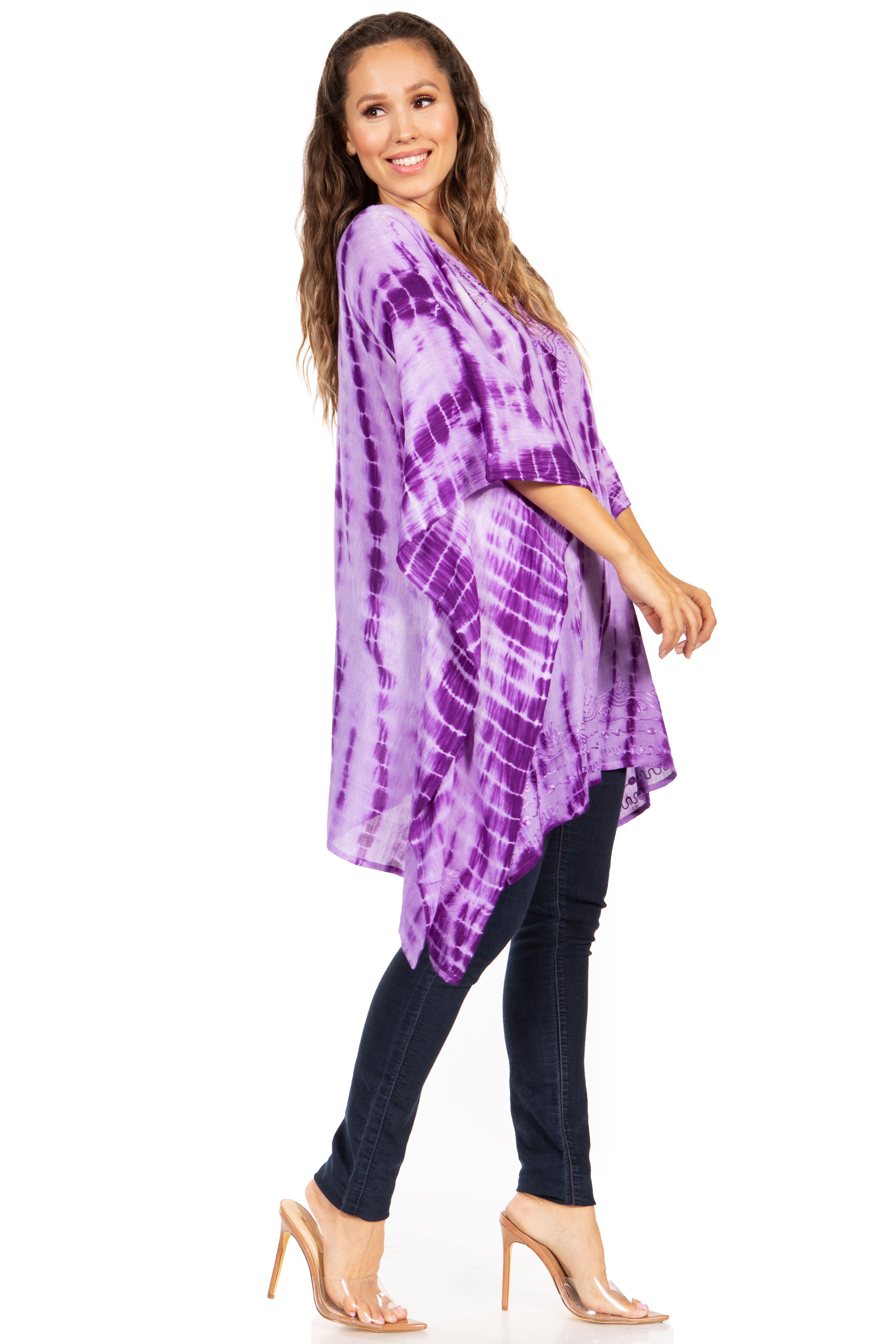 Woman wearing a purple tie-dye kimono over a black outfit on a white background