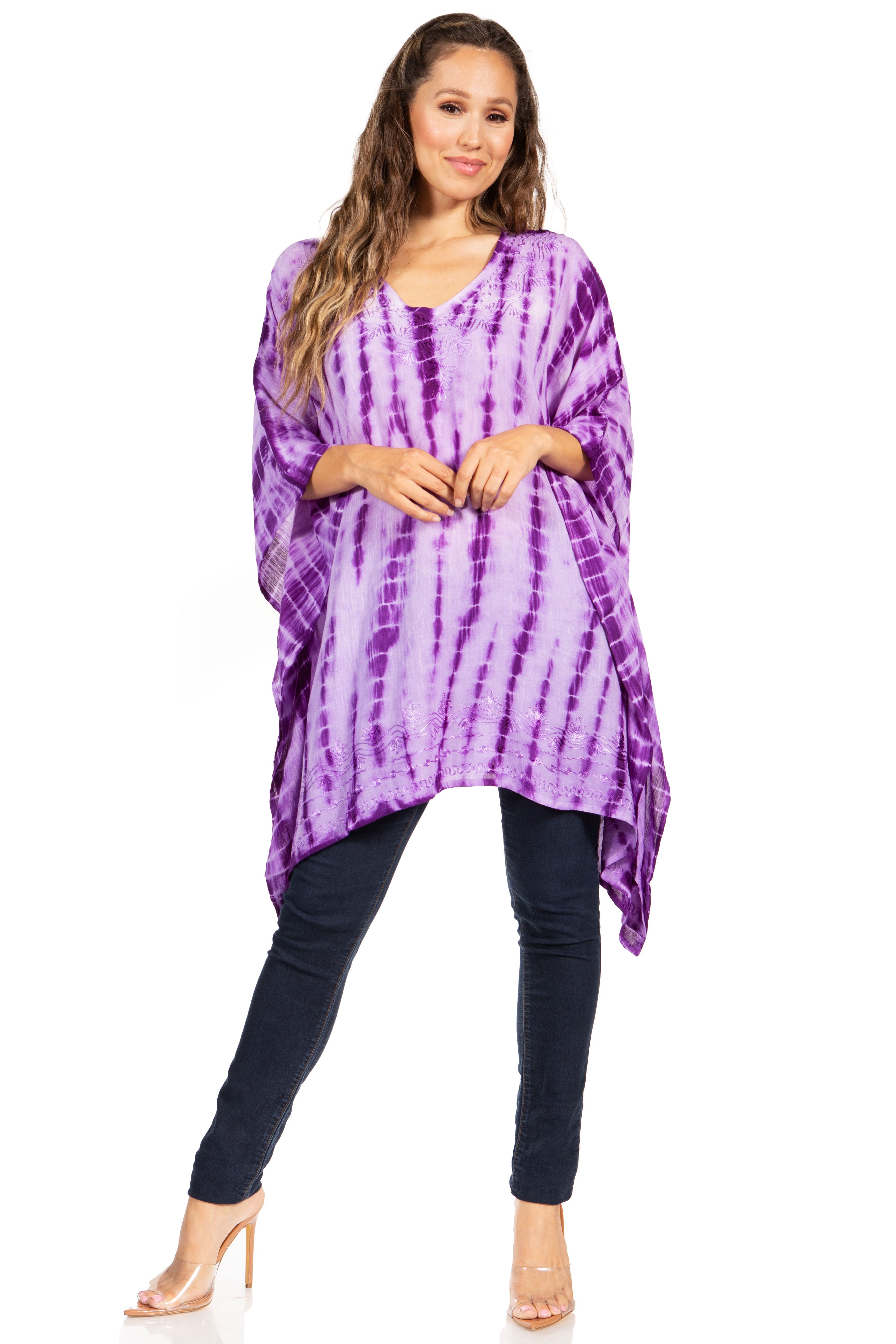 Woman wearing a purple tie-dye top and black pants on a white background